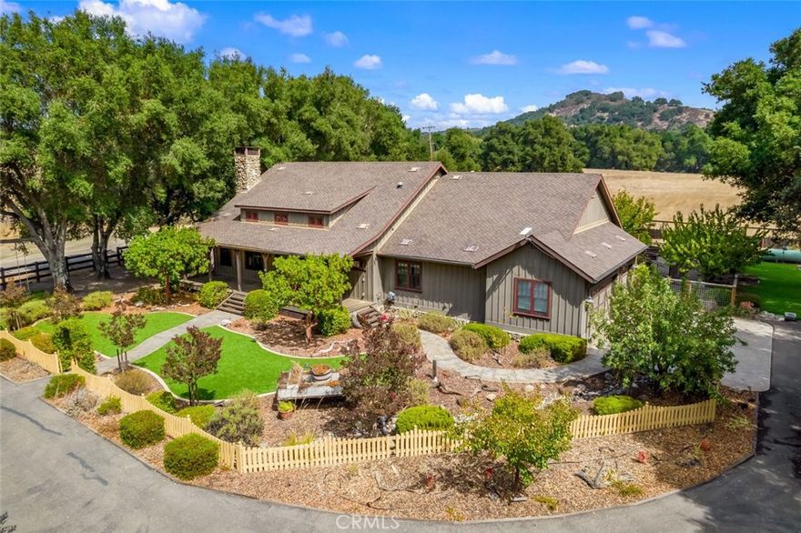 This breathtaking Arroyo Grande Estate blends rustic charm with refined luxury, offering scenic views and impeccable craftsmanship. The main residence features 3 bedrooms, 2 bathrooms, and 2,088 square feet of thoughtfully designed living space, all framed by a stunning wraparound porch and manicured landscaping.



Inside, soaring wood beam cathedral ceilings, quarter sewn white oak flooring, rich wood-trimmed windows, and a floor-to-ceiling stone fireplace anchors the expansive great room. Recessed lighting, ceiling fans, and timeless finishes create a warm, inviting atmosphere. 



The custom chef’s kitchen is a showstopper with granite and marble countertops, stone tile backsplash, a Wolf 6-burner stove with pot filler, farmhouse sink, Sub-Zero refrigerator, dishwasher, built-in microwave, and an oversized island with granite bar—perfect for gatherings. The adjacent dining area features a designer chandelier with crafted metalwork and matching sconces, overlooking the serene backyard oasis.



Outdoors, enjoy your own entertainer’s paradise: a picturesque garden path leads to a fully-equipped outdoor kitchen complete with stone pizza oven, Santa Maria-style BBQ, covered patio, and fire pit—all surrounded by lush landscaping and peaceful views. 



The spacious primary suite offers a luxurious escape with a walk-in closet and spa-inspired ensuite featuring a dual-sink vanity, soaking tub, and a stone tile walk-in shower with dual shower heads. Two additional bedrooms are light-filled and airy, sharing a beautifully updated full bathroom with stone accents and dual vanity. Extra hall storage includes a large Cannon safe for security and peace of mind. An attached 3-car garage completes the main home.



Beyond the primary residence, this property features a charming 532 sq ft upstairs barn apartment—perfect for guests, rental income, or multi-generational living. The apartment includes one bedroom, one bathroom, a full kitchen, walk-in shower, and breathtaking views stretching to the Los Padres National Forest.



Equestrian and ranch amenities abound with a 4-stall barn featuring pasture runs, a tack room with sink and laundry hookups, dedicated ATV bay, separate hay barn, large fenced pastures, and a round pen.



Whether you're looking for a serene country escape, a working ranch, or an entertainer’s haven, this one-of-a-kind property delivers it all. Don’t miss your opportunity to own this unparalleled slice of Central Coast paradise.