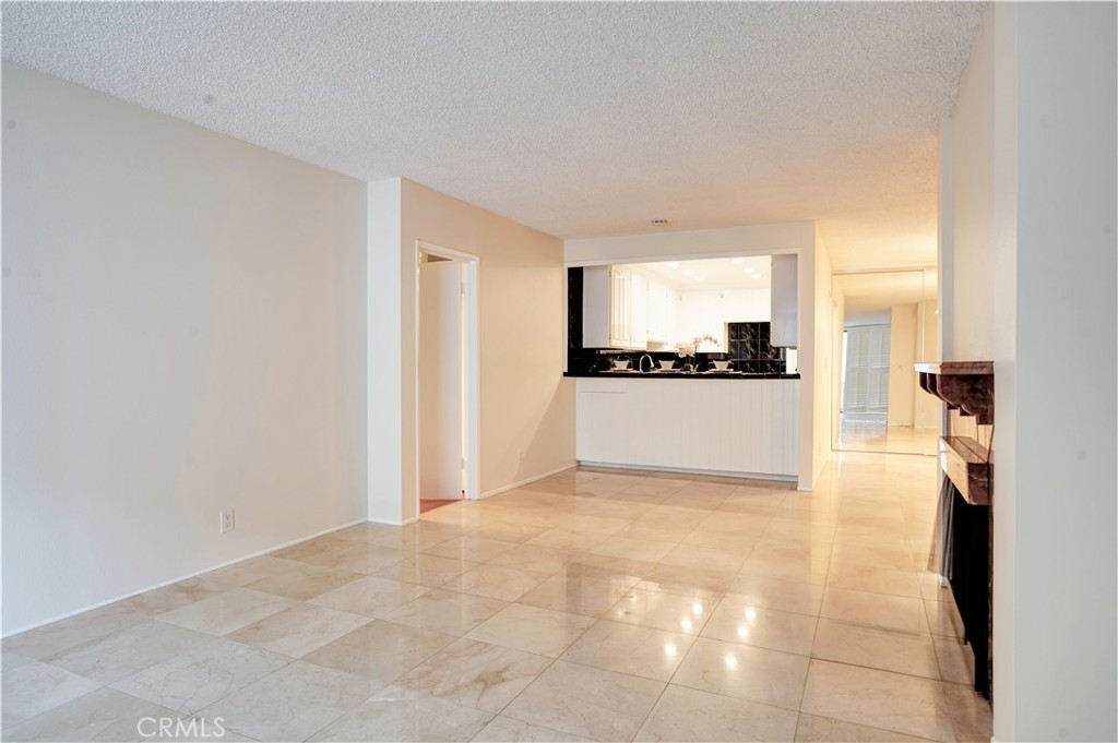 Wonderful 2 bedroom, 2 bath south facing condo perfect for entertaining and steps from the Wilshire Corridor! The spacious dining room and kitchen feature recessed lighting, beautifully tiled floors and an ideal floor plan which opens to the large living room w/fireplace and great outdoor private patio. Primary suite with bathroom, additional cabinetry and vanity and huge walk-in closet which is opposite the living room from the other bedroom and bath providing extra privacy. Amenities include pool, spa, exercise room and sauna. Abundant closet space and 2 gated and secure parking spaces. Excellent location