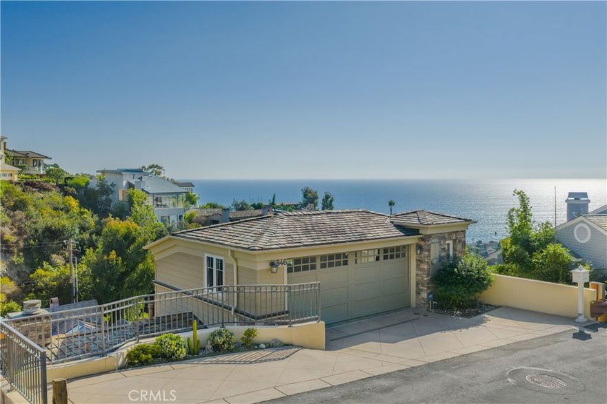 A stunning coastal Chris Light-designed residence, perfectly positioned to capture some of the most breathtaking, panoramic ocean views Laguna Beach has to offer. The main level of this private residence lends itself to everyday modern living as well as entertaining in style, with two distinct and spacious sitting areas offering remarkable flexibility of layout. The attached deck is large enough for hosting gatherings with a stunning ocean backdrop. A sophisticated and well equipped kitchen on this floor is anchored by a spacious island and features custom white cabinetry along with a suite of top-of-the-line appliances. The more formal of the two sitting areas flanks the fireplace, while the other features bespoke built-ins. A powder room completes this floor. On the lower level, the primary suite is a private Pacific-facing oasis, with a spacious, tranquil bedroom and a luxurious ensuite bathroom: a spa-like retreat, it is clad in Carrara marble. The dedicated balcony is yet another vantage point for taking in the magnificent surroundings of this property. Two secondary bedrooms of ample proportions and a guest bath can also be found on the lower level. Refined finishes abound throughout this home, from hardwood flooring to natural stone and classic millwork details including coffered ceilings. Whole house highlights include an elevator which connects all levels, air conditioning throughout, updated appliances, and built out closets. Sited on a quiet street, this residence offers privacy while located just minutes away from Laguna’s vibrant downtown, its renowned beaches, and boutiques.
