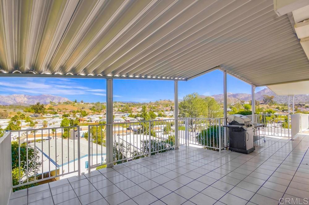 Beautifully maintained 2-bedroom, 2-bath home with stunning panoramic views of the lake and surrounding mountains! Relax on the spacious, tiled covered porch—perfect for soaking in the scenery—with steps leading to a private concrete patio and low-maintenance yard. A connected gas grill adds convenience for outdoor entertaining, while the porch also provides access to bonus exterior closet storage. Inside, the tiled flooring flows through the kitchen and dining area, which offers ample cabinetry and storage. Both bedrooms feature built-in closet organizers and cozy carpeting. An additional bonus room, currently used as an office, boasts wrap-around windows showcasing incredible views—note: this space is not included in the total square footage. The exterior offers low-maintenance landscaping, a large storage shed/workshop, and a widened driveway. Located in a 55+ community where you own the land and enjoy a low HOA of just $213/month!
