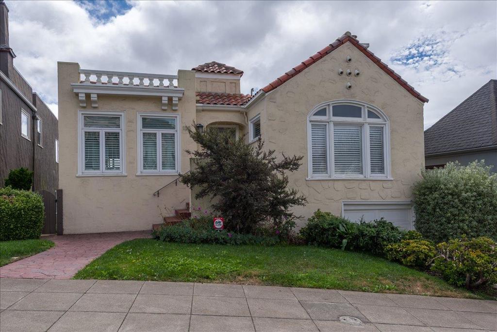 Nestled in Mt. Davidson Manor, this Spanish Mediterranean home blends timeless style with modern comforts. Across three levels, this four-bed, four full and two half-bath residence is perfect for entertaining, relaxation, and everyday living with lovely city and ocean vistas. The main level presents a grand living room featuring recessed ceilings, a wood-burning fireplace, and beautiful hardwood floors. An elegant dining area flows into a generous kitchen with granite counters, Bertazzoni range, and ample storage. Two bedrooms, including a serene primary suite with charming views and a spa-inspired bath, complete this floor. The middle level is designed for both gathering and retreat, with a spacious family room opening to a deck for indoor-outdoor living. This level also includes two bedrooms, 2.5 baths, laundry, and access to both the garage and a separate exterior entrance. The lower level offers a flexible media room with half bath and access to a large deck overlooking a terraced yard. The backyard features multiple zones for entertaining and play, with tiled patios, and garden areas. A short stroll to Ocean Avenues shops, cafés, Whole Foods, and public transit, with quick access to 101/280, this home offers comfort and convenience in a serene San Francisco neighborhood.