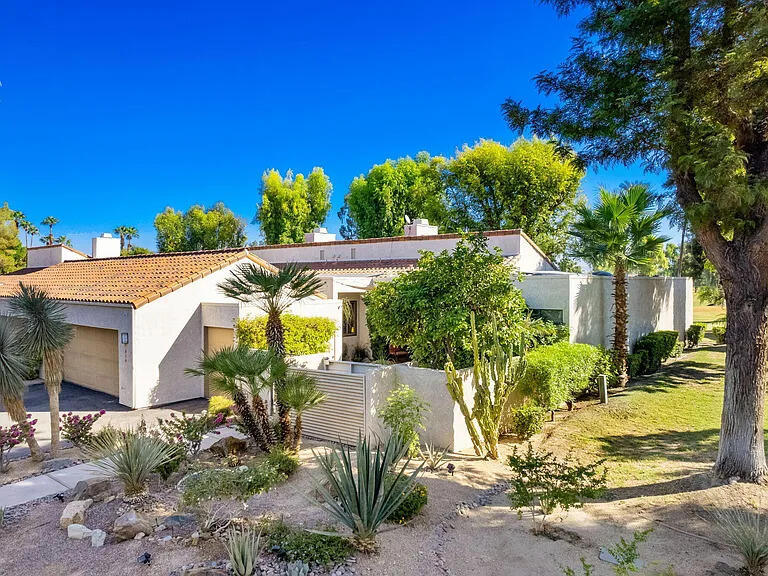 Expansive fairway views, tasteful upgrades, and a private courtyard oasis define this stunning Golf Villa in prestigious Mission Hills Country Club. Located on the Arnold Palmer Course, the East-facing orientation means lower energy bills and greater comfort than west or south facing homes. Large three bedroom, plus den, three bath, inside the spacious 2,227 SF home offers soaring beamed ceilings, a custom fireplace, and an entertainer's wet bar that opens seamlessly to an extended back patio with serene golf course vistas. The kitchen features granite countertops, all appliances, and a plethora of rich cabinetry, connecting to a light-filled dining area. The spacious primary suite boasts refinished double vanities, a spa tub, and an upgraded walk-in shower. Two guest suites offer flexible space for family, friends, or a home office, all with custom California Closets. Enjoy indoor-outdoor living with an in-wall speaker system, two car plus golf cart garage, and an exceptional 100 years remaining on the land lease. Your ideal desert retreat awaits in coveted Rancho Mirage.