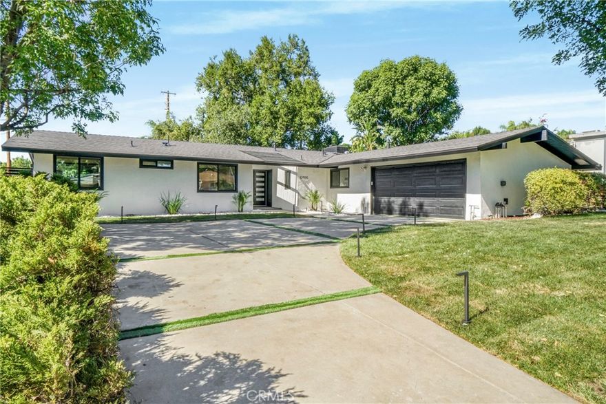 Modern Luxury Awaits – A Stunning Single-Story Transformation! Step inside this jaw-dropping 4-bedroom, 3-bath modern masterpiece—a home that has been completely reimagined from the ground up with high-end finishes, designer touches, and an effortless flow that defines contemporary living. From the moment you arrive, the grand double-door entry and open, sunlit floor plan will take your breath away. Natural light pours in through the skylight, highlighting the sleek new laminate floors, custom wood veneer accent panels with LED lighting, and a striking porcelain-tiled fireplace that sets the perfect tone for modern elegance. The state-of-the-art kitchen is pure perfection — featuring all-new cabinetry, quartz countertops with waterfalls, brand new modern appliances and a full designer backsplash that ties it all together. Whether you’re hosting a dinner party or enjoying a quiet breakfast, this kitchen is designed to impress.Every detail has been thoughtfully upgraded — from the brand-new roof and electrical panel to new energy-efficient windows, doors, and lighting throughout. The home’s spacious bedrooms offer plenty of storage, while the separate laundry room adds extra convenience.Step outside to your private backyard oasis, complete with new sprinklers, lush green grass, and a modern new gate. It’s the perfect space for entertaining, barbecues, or simply soaking up the sunshine.This isn’t just a remodel — it’s a complete reinvention of what modern living should be. Sleek. Stylish. Move-in ready.