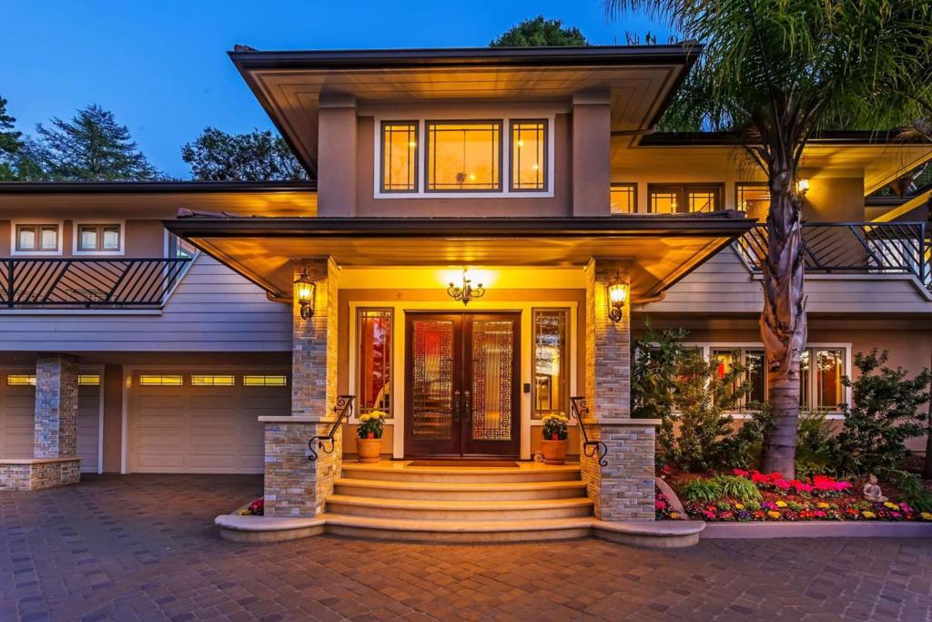 Gated Frank Lloyd Wright-inspired Phenomenal Luxury Grand Home situated on 0.41 acre lot. Custom-designed Security Gate opens to private paved driveway. Designer Staircase w/ decor railing leads to voluminous Living Room, Family Room, Kitchen, Dining Room & 3 Bedroom Suites. Gourmet Kitchen w/ Top-of-the-Line Thermador stainless steel appliances, commercial-grade 48-inch gas range w/ 54-inch hood & double ovens, double refrigerators/freezers, large Granite Island, Custom Omega Cabinetry. Hand-scraped hardwood flooring, High-end Picasso Lighting fixtures, monumental custom Crown Moulding & Columns, Designer Finishes thru-out. 2 gorgeous powder/guest bathrooms, 3 central A/C zones, 3 gas fireplaces, high-end plumbing fixtures & cabinetry. Exquisite Master Suite comes w/ luxury bathroom, see-thru fireplace, steam shower, floor tile warmer, large walk-in custom cherrywood closets, slab quartzite, European porcelain & glass tiles thru-out, top-of-the-line "Fabrica" carpeting. Bedrooms suites w/ balcony. Cinema-quality media center. Oversized attached 4-car garage, 1200+sq/ft bonus storage space. Whole-home sound speakers & security system, 2 wet bars, 2 laundry rooms. Too many features to list! Mini-park rear yard w/ great views.