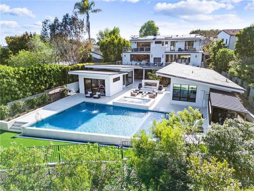 Introducing a 2018-built contemporary masterpiece nestled in the coveted neighborhood of Corona Highlands, right in the heart of Corona del Mar. Wake up to breathtaking sunrises and panoramic views overlooking the iconic Pelican Hill Golf Course.



As you step through the oversized glass pivot door, you're immediately met with a captivating arrival. The main level is designed for seamless indoor-outdoor living, with floor-to-ceiling Fleetwood sliding doors that open to a spectacular pool and spa, fire features, and endless views of the golf course.



The main floor also includes a guest suite with a full bathroom, a striking temperature-controlled glass wine cellar that holds over 600 bottles, and an open-concept living room centered around a sleek double-sided fireplace. The chef’s kitchen is outfitted with stainless steel Thermador appliances, a walk-in pantry, quartz countertops, and opens to a spacious balcony ideal for outdoor dining or lounging.



Upstairs, your private sanctuary awaits. The primary suite offers a cozy fireplace, dual oversized walk-in closets, and a spa-like bath featuring brushed marble floors, a soaking tub, dual vanities, and a stunning all-glass shower. Floor-to-ceiling sliding doors open to a private terrace—perfect for taking in the serenity of nature and the golf course views in complete privacy. Two additional en-suite bedrooms and a spacious laundry room complete the upper level.



Downstairs is an entertainer’s paradise, featuring a custom movie theater with a 120” screen, a game room, and a full bar equipped with beverage fridges, an ice maker, and ample seating. A whole-home surround sound system enhances the ambiance both inside and out.



What truly sets this home apart is the one-of-a-kind, $3M custom-designed backyard. Designed to feel like your own private resort, it boasts a show-stopping pool and spa with fire bowls and water features, lush landscaping, an outdoor kitchen and BBQ, dining space, and two expansive detached ADUs—perfect for guests or multi-generational living. A luxurious steam room completes the experience. In Addition, fully owned solar.  



This home feels like a permanent vacation—where every day is elevated by luxury, design, and unforgettable views. With a generous three-car garage, there’s plenty of room for your cars, golf cart, or weekend toys—rounding out the ultimate coastal lifestyle.