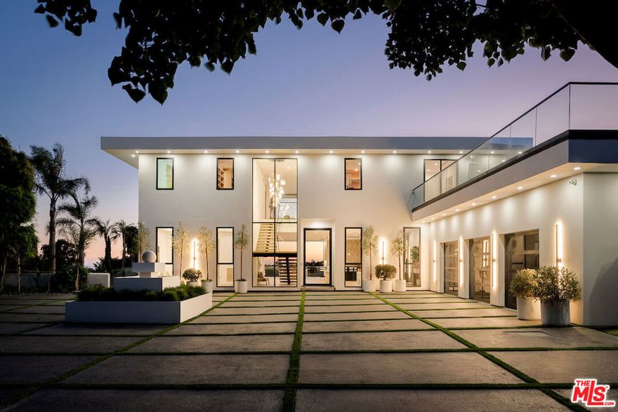 Discover a Malibu New Construction Ocean View estate minutes from Point Dume and set on over 2 acres of spectacular lush landscape and a vineyard.  At the end of a private cul de sac, this exceptional Modern Organic luxury estate is a serene compound with commanding views of the Pacific Ocean, rolling vineyards, and the Santa Monica Mountains. From the moment you arrive, the estate makes a statement with its gated and circular motor court and elegant approach that sets the tone for the sophistication within. Soaring ceilings, walls of glass, and expansive open living spaces seamlessly blur the lines between indoors and out, while over 3,000 square feet of wraparound ocean view decks invite you to take in the ever-changing ocean and Tuscany inspired 1 acre vineyard vistas. Every detail of the estate has been carefully curated with the highest level of craftsmanship and design. Fleetwood windows and doors frame dramatic sight lines, while custom white oak built-ins, handmade zellige tiles, and striking stone selections such as Taj Mahal quartzite and leathered granite create a refined, organic palette throughout. The open-concept living area flows effortlessly into the chef's kitchen featuring a 12-foot island clad in leathered stone, top-of-the-line Miele appliances, lime-washed walls, and a large walk-in pantry. The thoughtful floor plan offers five bedrooms and five bathrooms, including two bedrooms on the main level. Upstairs, the primary suite is a true sanctuary with dual closets, a private sitting room, and a spa-inspired bath dressed in Taj Mahal quartzite. The upper level also includes two additional bedrooms and a spacious family lounge designed for relaxed living. An elevator connects both levels with ease. World-class amenities elevate the lifestyle experience, including a state-of-the-art home theater, wine cellar, stylish bar and lounge, and an innovative indoor/outdoor gym that makes fitness a daily indulgence. The outdoor spaces are equally captivating. Resort-like grounds feature a sparkling pool and spa, built-in fire pit, custom barbecue, and an expansive grassy pad of nearly 4,000 square feet with a golf practice area ideal for entertaining, recreation, or simply soaking in the tranquility of your surroundings. The property has been designed for convenience and security, with a four-car garage, video intercom system, and ample additional parking for over 10 vehicles, including space for an Airstream or boat via private side yard access. This new construction secluded estate by architect Itay Mane represents a rare opportunity to own an ocean view retreat in Malibu, complete with a uniquely picturesque vineyard, perfectly positioned near Point Dume and Malibu beachside conveniences.