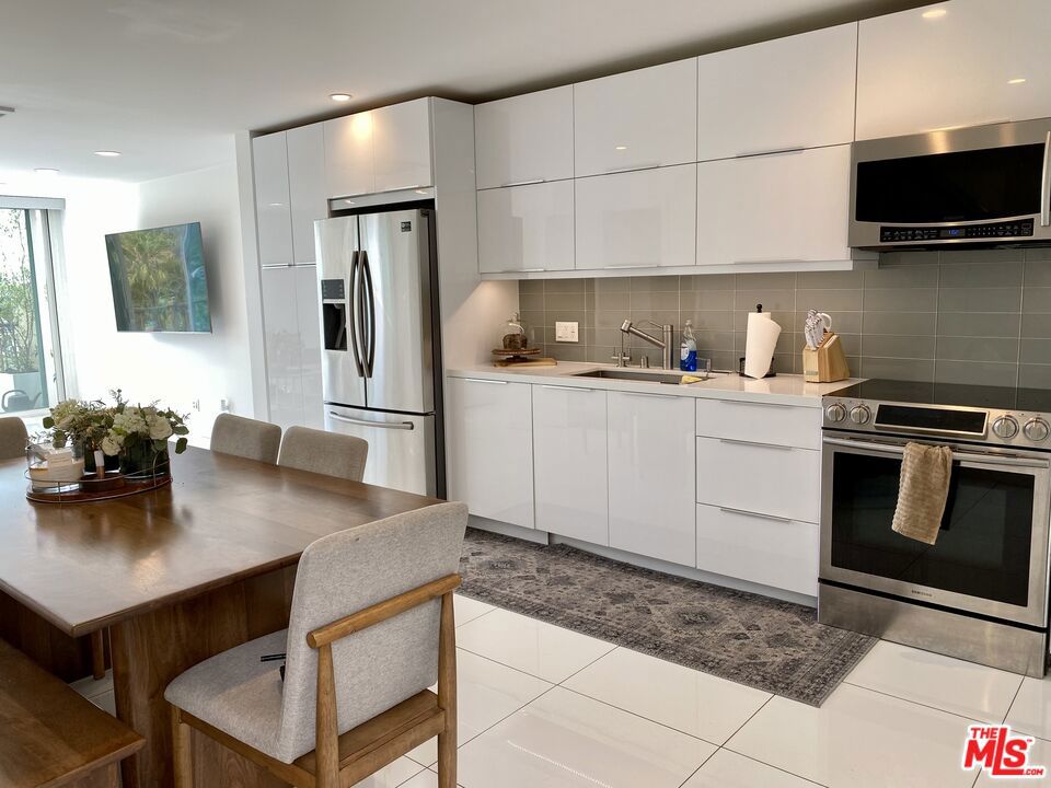 Location, Views, Amenities! Enjoy Santa Monica Bay ocean views and panoramic mountain views from this coveted central Malibu two-bedroom, one-and-a-half-bath townhome style condo (no one living above or below the unit) tucked away from Pacific Coast Highway in the guard-gated Malibu Canyon Village community. Thoughtfully updated, this home blends modern sophistication with comfort featuring stainless steel appliances, crisp white stone floor tile downstairs, wide plank oak flooring upstairs, recessed lighting and custom features throughout. The sleek kitchen offers soft-close cabinetry, while every interior finish feels fresh and luxurious. Start your day with breathtaking sunrises, then take advantage of the resort style community amenities: a refreshing pool, tennis court, and a gym boasting panoramic ocean and mountain views. Two covered parking spaces and a guest pass add to the convenience. Currently tenant-occupied through August 2026 at a monthly rental rate of $6,000/month, this property also presents an investment opportunity. Ideally located near Malibu Farmer's Market, local dining and shopping, Pepperdine University, and Whole Foods, this townhome offers a lifestyle of beauty and ease.
