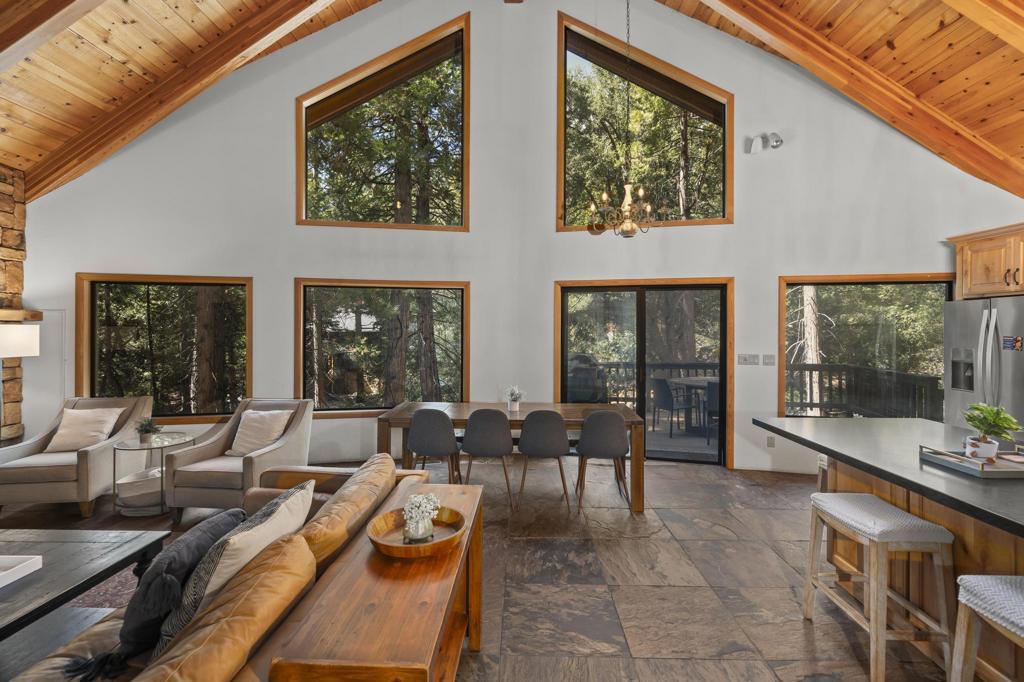 Turnkey Mountain Chalet on the Creek. Discover mountain living at its best in this fully furnished 3BR/3BA retreat nestled along the Creek. Step inside to an open floor plan where slate stone flooring flows through the great room, anchored by a cozy fireplace and a dramatic wall of windows that frame the forest and creek beyond. Natural light fills the space, creating a warm and inviting setting for relaxing or entertaining. Step onto the back deck for peek a boo views of Suicide Rock or enjoy Lily Rock from the front. Each bedroom offers comfort and privacy, while the thoughtful layout makes everyday living easy. With furnishings included, this home is truly move in ready, just bring your bags. Located minutes from Humber Park and Idyllwild's scenic hiking trails, it's ideal as a full time residence or a turnkey weekend escape. Don't wait to schedule your private showing and experience the magic of Idyllwild today!