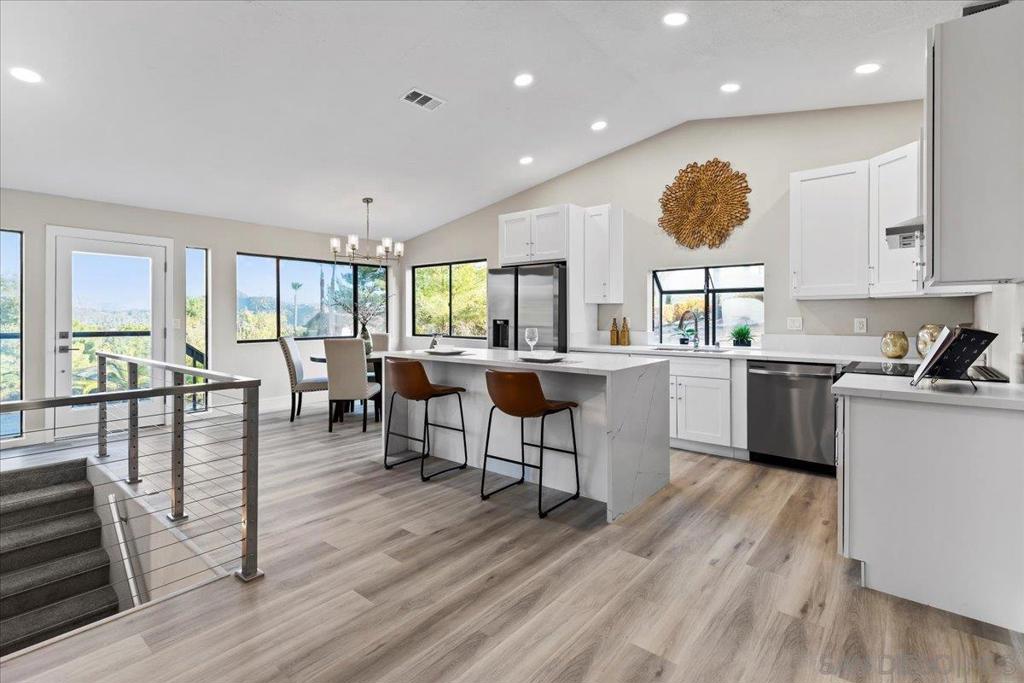 This beautifully remodeled 3-bedroom, 2-bath residence on a sprawling 0.75-acre lot is the perfect blend of elegance, comfort, and functionality. Move-in ready and bathed in natural light, the home welcomes you with a bright, open floor plan ideal for effortless living and seamless entertaining. The inviting dining area flows into a designer-curated kitchen featuring custom cabinetry, quartz countertops, statement lighting, stainless steel appliances, and soaring vaulted ceilings. The spacious family room invites relaxed gatherings, while the sunken living room—anchored by a warm fireplace—offers a cozy retreat to unwind and take in the soft evening glow. Downstairs, the luxurious primary suite offers a peaceful escape, complete with a fully remodeled spa-style bathroom adorned with dual vanities and high-end finishes. Set atop a scenic hillside, the home captures sweeping panoramic views of the valley below, tree-lined horizons, and the majestic eastern mountains beyond. Enjoy your morning coffee or evening wine from the elevated front balcony, where winter reveals snow-dusted peaks of Julian and Cuyamaca, and year-round greenery calms the spirit. Step into the private backyard oasis, where a shimmering pool beckons on warm days and the night sky comes alive for unforgettable stargazing. Backing directly to the expansive 650-acre Simon County Preserve, this property offers unmatched access to hiking, riding, and mountain biking trails. Located within the sought-after San Diego Country Estates, residents enjoy a lifestyle enriched by resort-style amenities and natural serenity. This is more than a home—it’s a retreat, a destination, and a rare opportunity not to be missed. ADU garage conversion plans included! Opportunities unlimited!