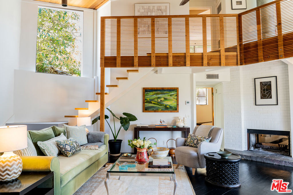 A rare Topanga Canyon treasure with sweeping, soul-stirring cross-canyon views. Designed by renowned architect Dennis McGuire, this iconic 70s architectural gem is tucked away on a full acre at the end of a private cul-de-sac in the coveted Postal Tract, Topanga's most desirable location. An enclave just steps from the trails of Topanga State Park. This 3-bedroom sanctuary blends organic designs, artisan touches with elegance and bold valiant representation: soaring open-beam ceilings, a striking double-sided fireplace, a gourmet kitchen for inspired living, and expansive wraparound decks that invite seamless indoor-outdoor flow. The large flat driveway, ample guest parking, and working two-car garage offer rare convenience in a canyon setting. A few miles from the Pacific Ocean, this is elevated Topanga living. Luxurious, soulful, and surrounded by nature.