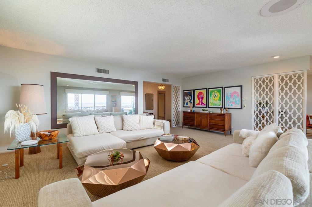 Vintage charm + stunning modern VIEWS! Perched above the cityscape with 180 degree perspectives, this mid-century penthouse turns back the clock with glamorous 60's vibes. Say hello to a jet-set era where martinis flowed and records spun on the built-in turntable. This flawlessly preserved residence crowns a boutique two-home building on the edge of Bankers Hill and Little Italy. Spanning over 2,600 sq ft, all on one level, this distinguished residence offers the feel of a single-family home with the ease of "lock and leave" condominium living. The owned solar system, 2 car garage, private laundry room and outdoor patio space are just a few notable features. The location is prime and walkable to restaurants, businesses and nightlife. This is more than a home—it’s a rare piece of San Diego’s architectural story. Don’t miss your chance to claim the city’s most iconic vantage point. Some of the other features you will love include: **Elegant stone fireplace **Huge cedar lined closets **Triple-pane windows **Owned solar **Central air conditioning and heating **Dumbwaiter to the garage below **Original Chamberlain electric cooktop **Walk-in pantry **Secured building access and mail delivered to lobby The residence also features a dedicated hobby/ceramics/woodworking room, providing creative space and storage space uncommon in most urban homes. Outdoors, enjoy a large covered terrace perfect for entertaining, planespotting and taking in colorful sunsets and twinkling lights. On the ground level there is an additional patio yard for gardening and relaxing. Within walking distance of Balboa Park, Little Italy, and Uptown’s vibrant restaurants and cafes, this is a lifestyle residence in every sense. Quick freeway access (I-5 and 163) makes commuting simple, though you may never want to leave the panoramic retreat waiting at home.