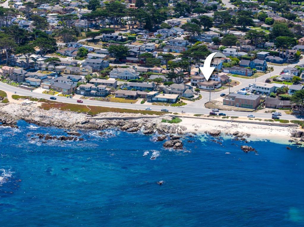 Introducing an exquisite ocean view retreat nestled in Pacific Grove's coveted Beach Tract - 25 Coral Street. This newly refreshed home is the perfect blend of 1970s charm and modern coastal living. The formal entry leads into an inviting living area with expansive windows framing breathtaking Monterey Bay views. A spacious formal dining room is ideal for entertaining and flows seamlessly into the living and kitchen areas. The recently refreshed kitchen and cozy nook overlook the ocean, perfect for lingering over morning coffee. The three generous size bedrooms, each offer abundant natural light and coastal ambiance. Two fully redesigned bathrooms boasting contemporary fixtures and spa like finishes. An office space provides a quiet work environment for those working from home. A two car garage offers storage plus a separate laundry room for efficiency and ease. A large concrete pad allows for additional parking for recreational vehicles, toys, or guest overflow. Wake up to panoramic seascapes and walk just steps to the coast or take a short stroll to downtown Pacific Grove's cafes, shops, galleries, and seaside trails. Perfectly positioned in a picturesque seaside community, this home captures the essence of Pacific Grove living.