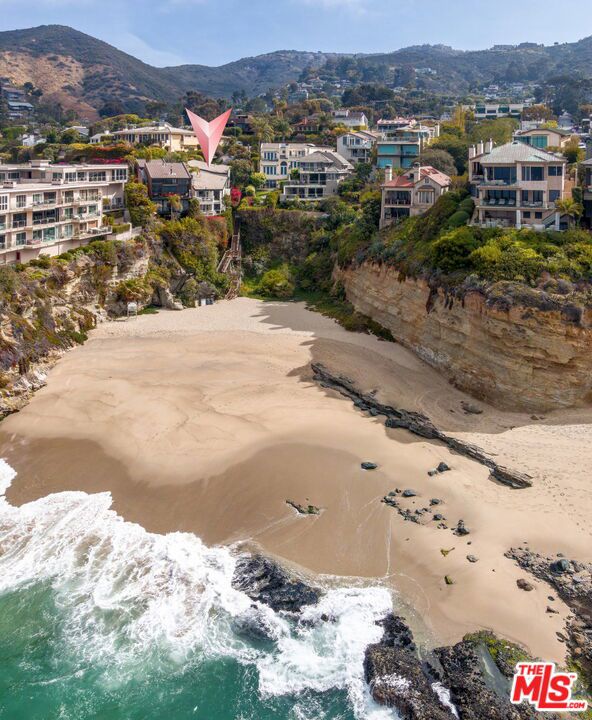 This quintessential beach front home checks all the boxes with sweeping breath-taking oceanfront views. Set on a private road, this peaceful and private oceanfront retreat is perfectly designed for coastal living and indoor-outdoor entertaining. The entry steps down to the main living area to a spacious great room with living, dining, and kitchen all facing the beach. The sprawling layout allows for maximum ocean, beach and bluff views from all areas of the home. Steps at the side of the house lead down to one of the most gorgeous best kept secrets in California. The large driveway allows for plenty of parking for guests as well as private designated street parking.