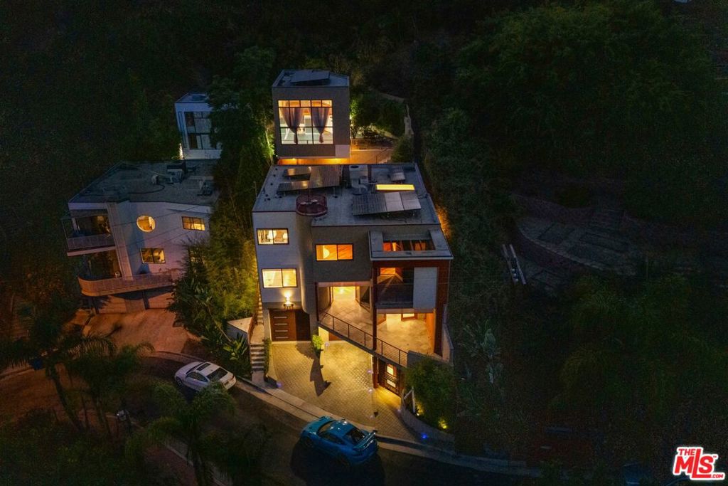 There are homes that are recognized and appreciated properly by very few. In a world overwhelmed by an avalanche of new construction focused on maximizing square footage and stacking ADUs, it's important to remember that the most meaningful things in life are not measurable by an appraiser's ruler. They are measured by energy, by presence, and by the ease with which life flows in a space. This home is a story of true love. A story of falling in love - with this home, and with each other - rooted in the understanding that details matter, and that craftsmanship does too. Because that is the only way to create something meaningful, something that endures through the decades. Welcome to Casa Alta - your serene perch above it all in the hills of Silver Lake Heights. A one-of-a-kind architectural compound where privacy, design, and inspiration meet not only for the moment - but for a lifetime. Per sempre, as some people with an intriguing accent might say. Your first introduction to this home begins with the garage - a thoughtfully executed two-car structure, with an additional two spots just outside in the driveway. The system behind the 30-panel solar array installed on the property could be found here too. From the first moment, your home greets you with natural materials - but it doesn't warm up to you right away. It says hello with cooler textures: concrete, metal, and stone. Think of this entry foyer as a secured portal that could easily transform into a lounge or bar area. As you enter the main level, you'll find the open floor plan that everyone desires. Not the kind of openness that feels like a warehouse or an echo chamber, but a deliberate, nuanced layout where the living room, kitchen, and dining areas coexist with balance and autonomy. The luxurious kitchen (top-of-the-line appliances from Fisher & Paykel, Bosch, custom cabinets, etc) steps aside gracefully, letting the view and the natural flow of the space take center stage. The home begins to soften here, with slate tiles placed where needed, and the warmth of Brazilian Tigerwood flooring grounding the entire level. A massive wraparound balcony floods the interiors with light, breeze, and life.One thoughtful feature is the outdoor staircase - perfect for entertaining - allowing guests to reach the backyard from the main level or even the street, without entering private spaces like the bedrooms. Because there are some corners meant to remain invitation only. The home's consistency and flow are unparalleled. And nowhere is that more evident than in the primary suite. Exposed beams in the bedroom carry on a visual dialogue with the Brazilian Tigerwood flooring, echoing the green hills of Silver Lake and Echo Park seen just outside your windows. A cedar-lined walk-in closet elevates the organic feel of the space, and of course - a private balcony is essential when you have views like these. The bathroom is an experience unto itself, with a steam shower, hammered copper sinks, and an oversized iron soaking tub - a testament to craftsmanship and taste. Two additional bedrooms complete this floor - one of which has direct access to a perfectly manicured private backyard. But perhaps the most striking reveal is the detached studio - complete with its own secret garden. A jewel box perched atop the hill that will inspire even the most grounded and rational among us. This flexible space is ready to meet whatever purpose your imagination can dream up, including possible conversion to an ADU. Directly beside the house is a terraced lot - ripe for a vegetable garden, or even another home. The separate parcel, over 9,000 square feet in size, is included in this sale. Not all homes are created equal. Casa Alta is unique in countless ways - and now, we're in search of someone equally special. Someone who doesn't just understand this home, but feels it. Someone who can appreciate it for what it is, for what it could be, and for who they themselves could become while living here.