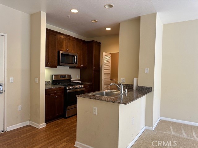 Welcome to Avenue One Community, centrally located in the heart of Irvine! This stunning two-bedroom, two-bathroom condo provides a spacious open floor plan with beautiful greenbelt views from the second floor. Natural light pours in through large windows, highlighting the expansive living room. The kitchen is equipped with a refrigerator and gas stove for all your culinary needs. Neatly tucked away in a walk-in closet is an in-unit laundry area complete with a washer and dryer. The property also includes two assigned parking spaces within a secure parking structure. Residents enjoy access to a variety of amenities, including community-organized activities, a business center, conference room, pool, spa, fitness center, and indoor basketball court. Outdoor amenities include BBQ and picnic areas, while the clubhouse features a media lounge with a plasma screen. Additional perks include a putting green, billiard room, and tot lot, making this community ideal for all ages.