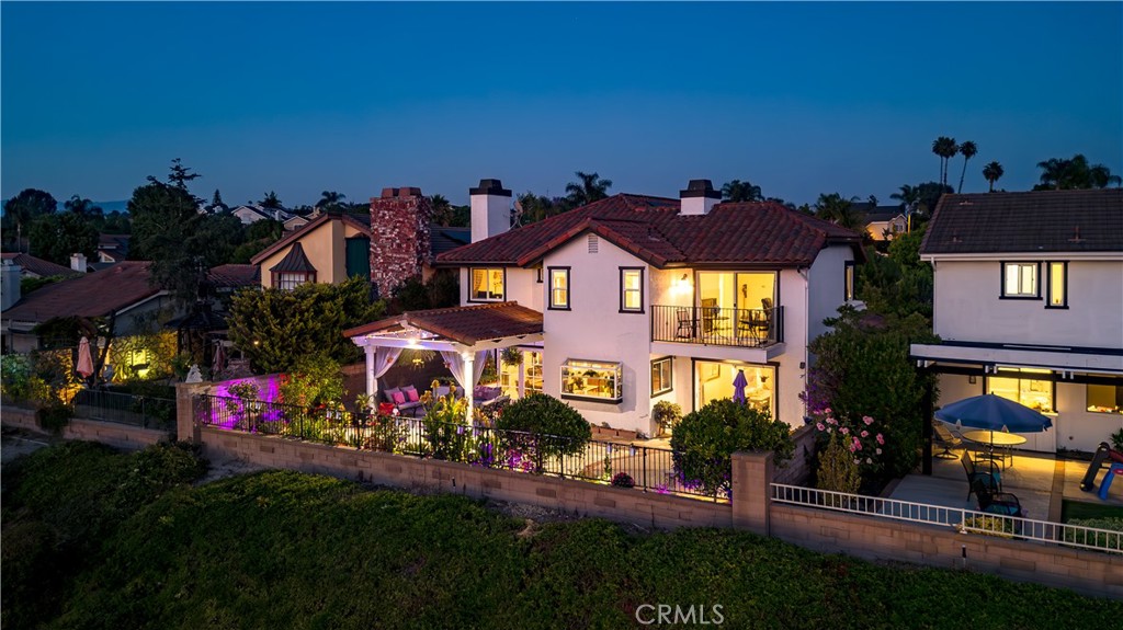 This stately yet casually sophisticated home mixes layers of texture both inside and out to create this idyllic residence in the heart of Mission Viejo. Every facet of the home has been thoughtfully curated to offer a living experience that is not only practical but warm, inviting, and visually striking. With an entry area that spans two stories, the home maintains a spacious feel, with a central staircase that serves as a unifying element. To enhance the openness of the living area, the use of large windows add to the home's sense of grandeur. Further through the property, the kitchen was envisioned as a spacious hub for gathering and entertaining. Upstairs, the first room you come into is “The Gathering Place”. This is the family's game room and entertaining area. With a full functioning bar, video gaming area, and sporting tables, this unique room definitely plays the role as the gathering room for friends and family. Furthermore, the primary bedroom offers expansive views of the surrounding hillsides. The en-suite creates a feel of simplicity yet elegance, with its large free standing bathtub and full open shower, this room gives the impression of a hotel suite. The owners focus was creating an integrated home with an expansive connection to the gardens and landscape which take advantage of the unique Southern California climate. They integrated an array of native greenery throughout the gardens that serve as transitions between the front and rear of the property. The jacuzzi with its grotto waterfall provides a calming setting with the sound of falling water. Each area has its unique feel while staying true to the overall theme and styling. While the visual aspects were modernized including all three bathrooms and the entirety of the flooring, many non visual elements were also looked at. The owners made sure to replace the HVAC system and fully replace the property with PEX piping in 2023. Also brand new high efficiency solar panels were added last year. But at night, the property takes on a new life. With lights shining from every corner inside and out, the property stands out from the rest of the neighborhood while enhancing the beauty of its curb appeal. Plus, with its desirable location, the property offers full membership to Lake Mission Viejo and all it's amenities. This home’s infusion of timelessness strikes a perfect balance between modern yet comfortable. The resulting home feels refreshed and ready for its next chapter.
