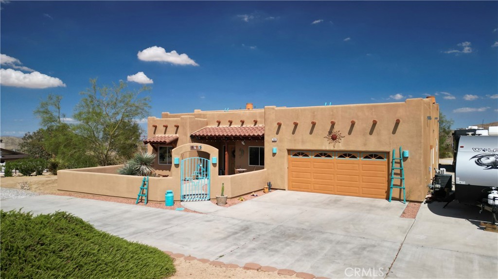 BUY or LEASE this fantastic Joshua Tree Home. Enter through the private courtyard and enjoy your privacy without giving up the perks of living with neighbors. This remodeled one-story home sits on a large lot and a paved street in Joshua Tree’s Friendly Hills neighborhood. You are close to the Joshua Tree Village with its farmers market, Hi-Desert Playhouse and music venue, coffee shops, fabulous eateries, the Joshua Tree National Park, visitors center, schools, and boutique shopping. The spacious open kitchen has been upgraded with granite counters and stainless-steel appliances. Brand-new travertine flooring throughout the home. The living room opens to a spacious backyard with a large patio featuring several sitting and dining areas, a pergola, a fire pit, mature trees, and a spa to help ease your troubles. Four bedrooms have captivating views of our unique desert ecosystem. The primary bedroom features a private five-piece bathroom with an upscale shower, a grand-looking spa bathtub, and a large walk-in closet. Convenient coffee station, indoor laundry room, high-efficiency washer, dryer, sink, and easy access to a finished two-car garage. Sun Run Solar keeps those utility bills in check while providing a battery backup. Ample pull-through RV parking with 50 Amp electrical RV hookup and water. Easy commute to Copper Mountain College, Hi-Desert Medical Center, Twentynine-Palms Marine Corp. Base, and the Town of Yucca Valley. The Palm Springs area is 40 minutes away and offers an international airport, world-class dining and entertainment, fabulous golf, spas, and shopping. Monthly lease: $2550.00. An option to lease to buy may also be available.