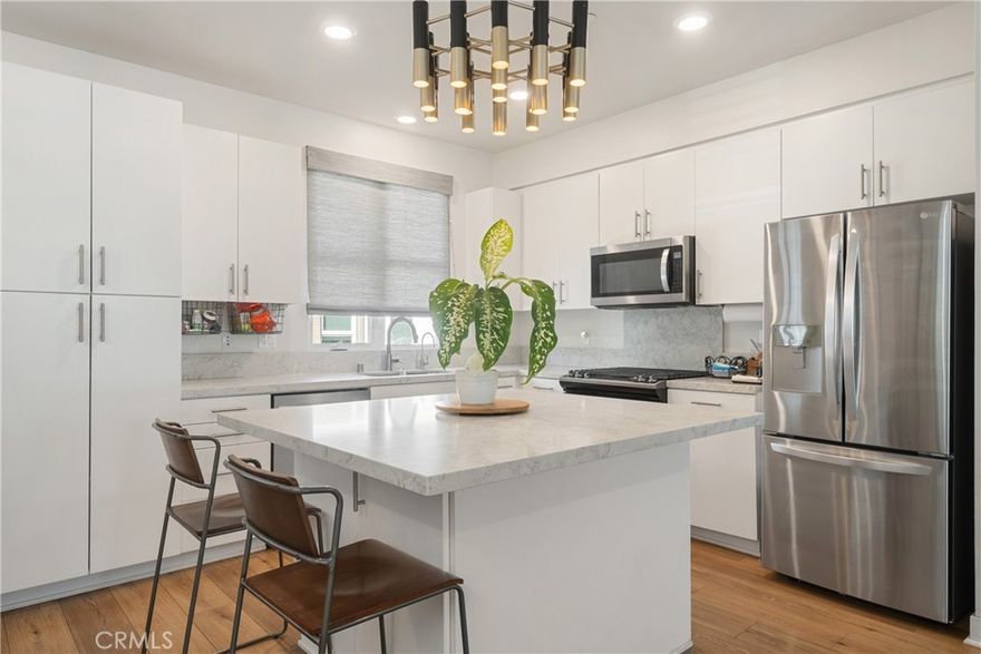 Welcome to 2700 E Chaucer Street #2, an elegant tri-level residence set in the heart of the highly desirable Riverpark Community in Cypress Park, offering an exceptional location with everything at your fingertips. With 4 bedrooms, 3.5 bathrooms, and over 1,900 square feet of thoughtfully designed living space, this home delivers a rare balance of sophistication, flexibility, and seamless day-to-day living.
The first level features a private suite with its own entrance, full bathroom, and outdoor patio—ideal for guests or extended family. Direct access to the attached two-car garage adds privacy and ease, while an expansive walk-in coat closet at the entryway provides excellent storage.
The main living level is filled with natural light and designed for hosting and gathering, showcasing high ceilings, expansive windows, and a cohesive open-concept layout. The chef-inspired kitchen features quartz countertops, custom cabinetry, stainless steel appliances, and a striking centered island. Adjacent to the kitchen, a dedicated flex space offers versatile use as a dining area, work-from-home office, play space, or lounge. A rare main-level powder room completes the level.
The top floor hosts a serene primary suite with an ensuite bathroom featuring dual sinks and a walk-in shower. Two well-sized bedrooms with custom closets, a full guest bathroom, and an upstairs laundry area complete the level.
The home has been updated throughout with new stair flooring, fresh interior paint, and modern light fixtures. Additional features include laminate wood flooring, dual-pane windows, custom window shutters, energy-efficient lighting, a tankless water heater, whole-home water filtration system, and an EV charger.
Ideally located just one block from the new Footbridge, residents enjoy easy access to Frogtown, the LA River bike path, and Rio de Los Angeles State Park, along with nearby cafés, dining, coffee shops, and freeway access. Minutes to DTLA’s Arts District, Silver Lake, Highland Park, Pasadena, Echo Park, Eagle Rock, and Glendale. A newly built community park is less than a one-minute walk away. Polished, vibrant, and centrally located—this is modern NELA living at its finest.