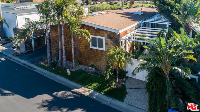 Rare home on the perimeter of Point Dume Club features large deck with beautiful canyon and ocean views. Charming cedar shake exterior. Interior with ash flooring, stone fireplace, upgraded bathrooms, white plantation shutters, large kitchen with stainless steel appliances. Nice open floor plan is very sunny and bright. Separate laundry room, central air and parking for 2 cars in carport.Amenities include pool, hot tub, clubhouse, tennis court. Walk to beautiful Westward/Zuma Beach. Easy breezy Malibu living.