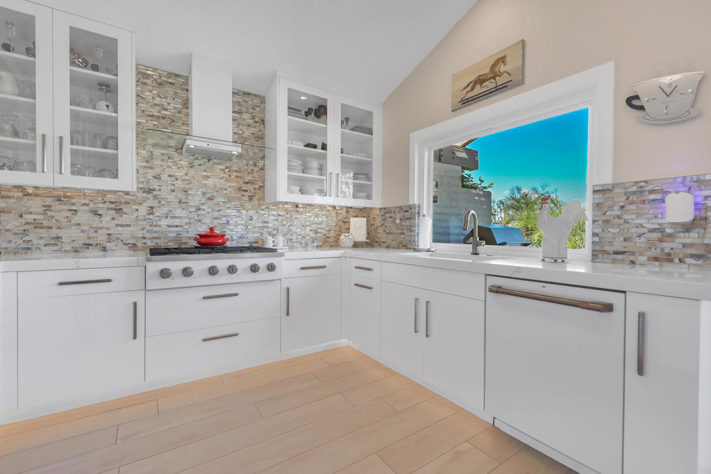Stunningly remodeled 2BD + den, 3.5BA Laramie model in The Lakes CC with 2,184 sq ft of luxury living! This beautiful home also has SOLAR to reduce those energy bills. New Bosch AC/ Heating and a new hot water heater in 2023. Enjoy breathtaking mountain, fairway & clubhouse views from the extended tiled patio with built-in BBQ, side burner, misting system & electric awnings. Interior features include a sleek electric linear fireplace, wet bar w/ wine cooler, 2 inch quartz counters and 5 matching bar stools, new dual paned windows (MILGARD) with electric shades, and Italian wood-look tile throughout. Wall removed between kitchen/living for open layout w/ 2 inch quartz counter top island & matching barstools. Kitchen boasts high end GE Cafe appliances, glass backsplash, & custom cabinetry. Under cabinet lighting and toe kick lighting. All baths remodeled w/raised cabinets and granite counters & shower surrounds. Den w/ French doors leads to built-out office, with outstanding storage. Bedrooms have wood shutters. Garage has plenty of cabinets, interlocking paver drive/walkway, courtyard with custom wrought iron gate. Offered partial furnished + golf cart included (Caddy Shack). Enjoy 27 holes of golf, 9 pickleball courts, tennis, bocce, fitness center & a world-class clubhouse in this guard-gated community! No expense has been spared on this move-in ready home .