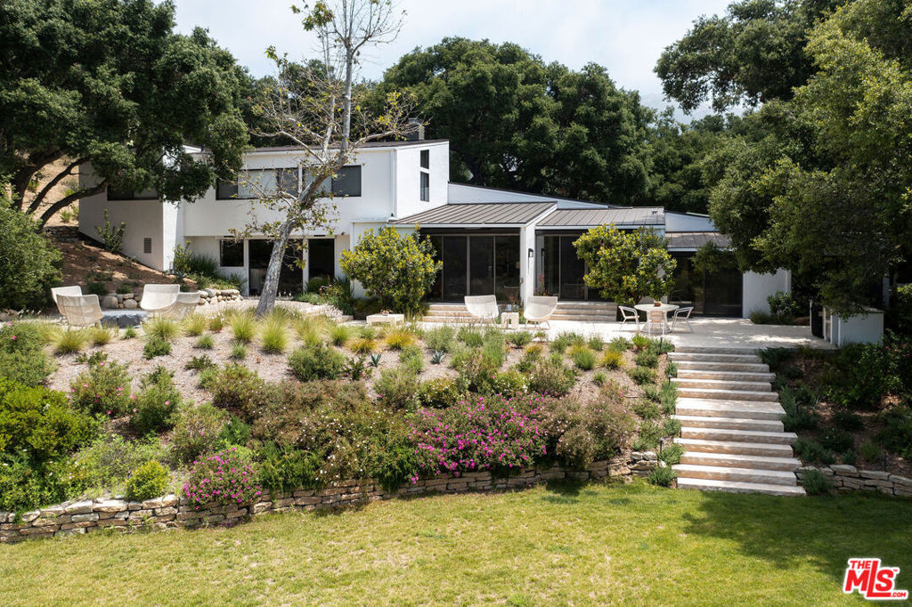 This Stunning home, designed by Peter Choate in 1977, was thoughtfully remolded to enhance the original open concept design. Set on 2+ acres amongst ancient Oaks, surrounded by nature and filled with light, the contextual gardens are highlighted with limestone and gravel patios, with cobblestone paths. All of the large picture windows in the home have views of the sculptural Oaks and Santa Monica Mts. Choate's uncanny sense of spatial proportions give this home a feeling of open space and cozy warmth at the same time. The gourmet kitchen opens to a large family room with day time dining, that flows to the formal dining room and spacious living room. Enjoy the fabulous Movie room with a 100" viewing screen which opens to the fire pit seating area for nightly star gazing. Just 7 minutes to downtown Malibu and 10 minutes to Calabasas proper. Dine at the local Saddlepeak Lodge or stroll the wonderful walkable neighborhood and enjoy the year round creek and surrounding hiking trails. Truly your own Relais & Chateaux adventure & stay!!