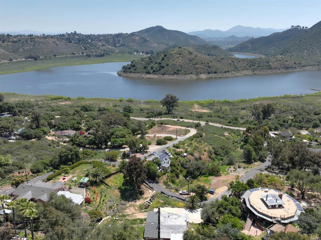 Investor’s Dream with Stunning Lake Views! This is a rare opportunity to bring your vision to life on a spacious 30,492 sq ft lot in peaceful Escondido—just minutes from the city. Permits are already in place for both the 3BR/3BA, 3,000 sq ft home and the septic system, along with plans for an additional 1,500 sq ft deck. Whether you’re building a custom residence or a multigenerational retreat, this property offers incredible potential in a beautiful, tucked-away setting. The home is not yet complete—ideal for those ready to build from the ground up. Buyer and agent to verify all information prior to close of escrow.