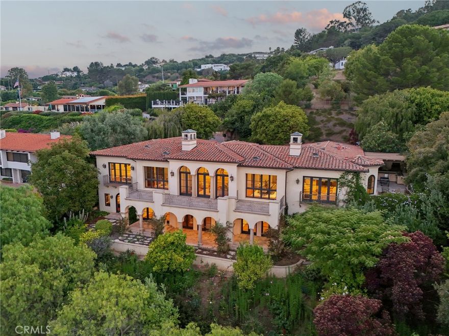 Mediterranean Villa Vibes with a Floor Plan That Lives Like a Dream. 



Big views? Check. Bold style? Absolutely. A layout that actually works for real life? Finally!



Welcome to your Mediterranean villa in the sky—perched in the prestigious Miraleste Estates of Rancho Palos Verdes, where sweeping views stretch from the Pacific Ocean to the harbor and all the way to snow-dusted mountains (yes, all three, and yes, it’s as magical as it sounds).



But the real magic? You enter on the main level—and that’s where the entire heart of the home is. Living room, kitchen, dining, and a primary suite that feels more like a five-star getaway—it's all right there. No stairs required. Downstairs is where the rest of the party lives, with all secondary bedrooms (each with their own ensuite!) perfectly tucked away for privacy, guests, or growing room. It’s a layout that lives like a single-story, but flexes like a forever home.



Step inside and let the wow begin—marble floors, a custom mosaic entry, and floor-to-ceiling glass that captures a postcard-worthy 180° panorama. Soaring ceilings, skylights, and rich cherry red oak floors create warmth and grandeur in equal measure.



The formal living room is pure drama, with a cozy fireplace and 3 sets of French doors that spill out to the view-soaked patio. And the European-style kitchen? A culinary showstopper, with rare marble countertops, custom cabinetry, pro-grade Wolf and Miele appliances, and a walk-in pantry ready to feed a crowd.



Need more? You’ve got 5 ensuite bedrooms (yes, every single one), a bonus half bath, a wine cellar, possible screening room, and large laundry room for effortless everyday living.



The primary suite is your private sanctuary—think fireplace, secluded terrace, dedicated office/library, spa bath with jetted tub and 7-head shower, and a closet that basically is a boutique.



Outside, the .35-acre lot offers lush gardens, roses, and fruit trees galore. Dreaming of a pool? There’s room. Dreaming of doing nothing? The space has that covered, too.



With a private circular driveway, two two-car garages, and instant access to Trump National, Terranea Resort, and Point Vicente Lighthouse, this isn’t just a home—it’s a coastal lifestyle with a capital L.



Bottom line? This Mediterranean villa lives smart, looks stunning, and feels like vacation every day. Make your move before someone else makes it theirs.