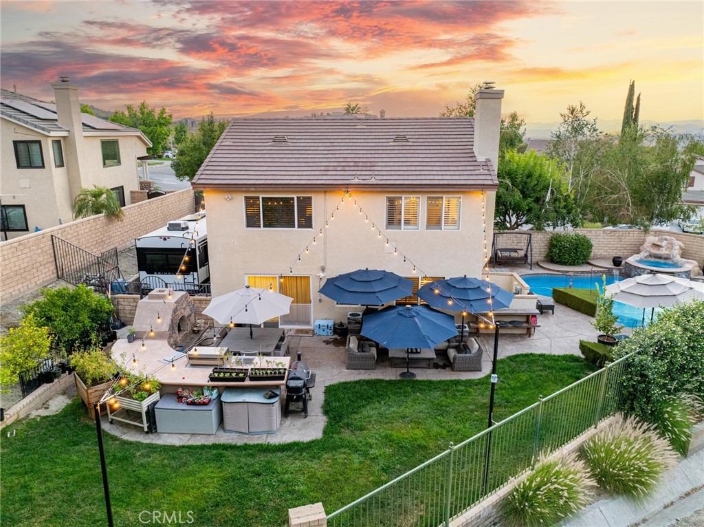 Welcome to your dream home in desirable Fair Oaks Ranch! This beautifully upgraded 4-bedroom + loft, 2.5-bath pool home is nestled on a premium 10,000+ sq ft lot with only one side neighbor and no rear neighbors. You’ll enjoy peace, space, and stunning outdoor living. Step inside to soaring vaulted ceilings in the living room with numerous windows providing amazing natural light. The formal dining room accommodates a large table to entertain and is highlighted by a stunning chandelier. The open-concept family room features custom built-ins, a stacked stone accent wall and surround sound. The heart of the home is the fully remodeled chef’s kitchen—featuring an oversized island with leathered quartzite counters, custom cabinetry with gold hardware, stainless steel appliances, pendant lighting, and a textured farmhouse sink. Whether you’re preparing meals or entertaining, you’ll love the gorgeous views of the backyard oasis from the kitchen windows. Downstairs also features one bedroom, a darling half bath with custom vanity and fixtures and a large laundry room. Upstairs you will find 3 bedrooms plus the spacious loft that could easily be converted to a 5th bedroom. The luxurious primary bathroom features a free-standing soaking tub, walk-in shower, custom walnut vanity, and an oversized walk-in closet with built-in organizers and extra shelving. Wood-like tile flooring, walnut doors, smart home light switches, wood shutters found throughout the home. The backyard is a true entertainer’s delight. A sparkling pool and spa fully equipped outdoor kitchen, and cozy fireplace make it the perfect space for gatherings and relaxation. Edison lights strung over the sitting area add warmth and charm, creating a magical ambiance for evening entertaining. Gated RV parking with water and 30-amp power. 3-car garage with built-in cabinetry. Ideally located minutes from local school, park, shopping and freeway access. This exceptional home offers style, privacy, and functionality in one of the area’s most sought-after communities.