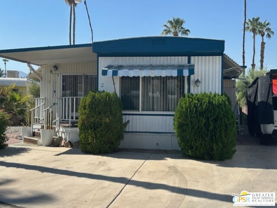 Vacation community with some year-round residents. 2-bedroom, 1-bath home features a spacious fenced backyard and an open dining and living room area that flows into the kitchen, equipped with 3-year-old appliances. 2 new mini splits in the living room and dining room, and a swamp cooler. The laundry is conveniently located in a hall closet. The property includes two sheds, one of which can be transformed into an office, gym, or artist studio. Centrally located between Palm Springs, Rancho Mirage, and other cities. Palm Springs International Airport is just 15 minutes away, and the Amtrak Train Station is 20 minutes away, offering free overnight parking. Residents can enjoy amenities such as a community pool, jacuzzi, shuffleboard tournaments, ping-pong, piano, pool table, card table, a community room with a kitchen, and an adjacent ballroom with a stage and banquet kitchen for larger gatherings. Tramview is a 55+ senior community with a space rent of approximately $915/month. Call for a private tour. Seller is reviewing all offers.