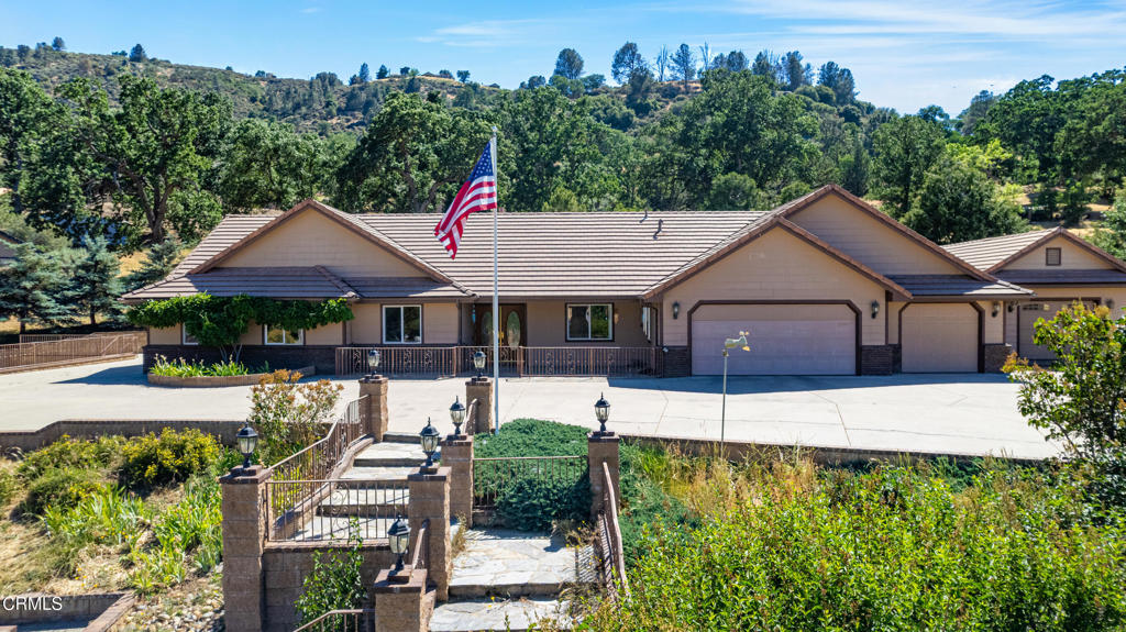 Where Moments Happen! Tucked inside the desirable gated community of Bear Valley Springs, this beautifully maintained custom home offers 2,902 SF of comfort and functionality on a spacious .99-acre corner lot. Built in 2002, the home welcomes you with glistening hardwood floors, tall ceilings, and a layout designed for both everyday living and entertaining. The formal dining room is ideal for gatherings, while the large (12'x57') enclosed sunroom, with built-in shelving, cabinetry, and a pass-through window to the kitchen, offers a bright and versatile space for relaxing, hobbies, or a home office.The kitchen is a true delight with rich granite countertops accented by shimmering flecks of blue, a walk-in pantry, and a cozy breakfast nook. The oversized primary suite offers a peaceful retreat with a large walk-in closet, dual vanities, a jetted Jacuzzi tub, and a separate shower.Additional features include central heat and air, two water heaters, a whole-house Generac generator, natural gas, durable cement siding, and a tile roof. An attached 3-car garage provides ample storage, while a separate detached 1-car garage has been used as a workshop with 220V outlets. With parking for up to 20 vehicles and an RV pad with a 30-amp connection, this property is ideal for those needing extra space and utility. Come experience the best of mountain living and see why it's not just a house, it's your home!