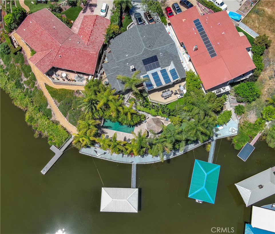 Live the Dream of Lakefront Living in Canyon Lake
Welcome to your slice of paradise on the water! This rare opportunity to own a stunning lakefront estate in the coveted Smugglers Cove. This home offers unparalleled views, lush landscaping, and a true vacation lifestyle—every day of the year.
Surrounded by mature palm trees, tropical flowers, and thoughtfully terraced grounds, this home boasts multiple outdoor entertainment areas perfect for everything from casual dining to poolside relaxation and boating adventures. The upper patio offers a tranquil lounge space with a built-in Wolf BBQ and sleek glass railing that preserves the breathtaking views. Just a few steps below, you’ll find a private saltwater PebbleTec pool with a waterfall feature, a grassy play area, and direct access to your own dock and 113 feet of secure sea wall—a waterfront dream come true.
An east-facing backyard provides the perfect balance of shade and sunlight, ideal for enjoying the outdoors without excessive afternoon heat. Another charming entertainment area features a thatch-covered circular table and built-in serving station—perfect for poolside gatherings.
Inside, the beautifully updated single-story home offers 3 bedrooms, 2 bathrooms. A designer kitchen with Sub-Zero refrigerator and gourmet wolf range and 2 dishwashers. A luxurious island and large picture windows that frame the stunning lake views. The great room is equipped with a premium Yamaha surround system and an impressive 80 inch Sony TV, creating a true home theatre experience. The great room boast dual sliding glass doors for seamless indoor-outdoor living. Additional upgrades include owned solar with 23 panels, tankless water heater, new "cool" roof and a spacious 2-car garage. For added peace of mind, the home also includes a built in alarm and video surveillance system.
Located within walking distance to Holiday Harbor, this home is part of a vibrant, gated community that includes a private lake, water skiing, fishing, a championship golf course, an equestrian center, beaches, parks, sport courts, a community lodge with a pool, and year-round events like fireworks shows and seasonal festivals.
Don’t miss this rare opportunity to own a lakefront oasis in one of Southern California’s most unique and amenity-rich communities. Come live where every day feels like a vacation.