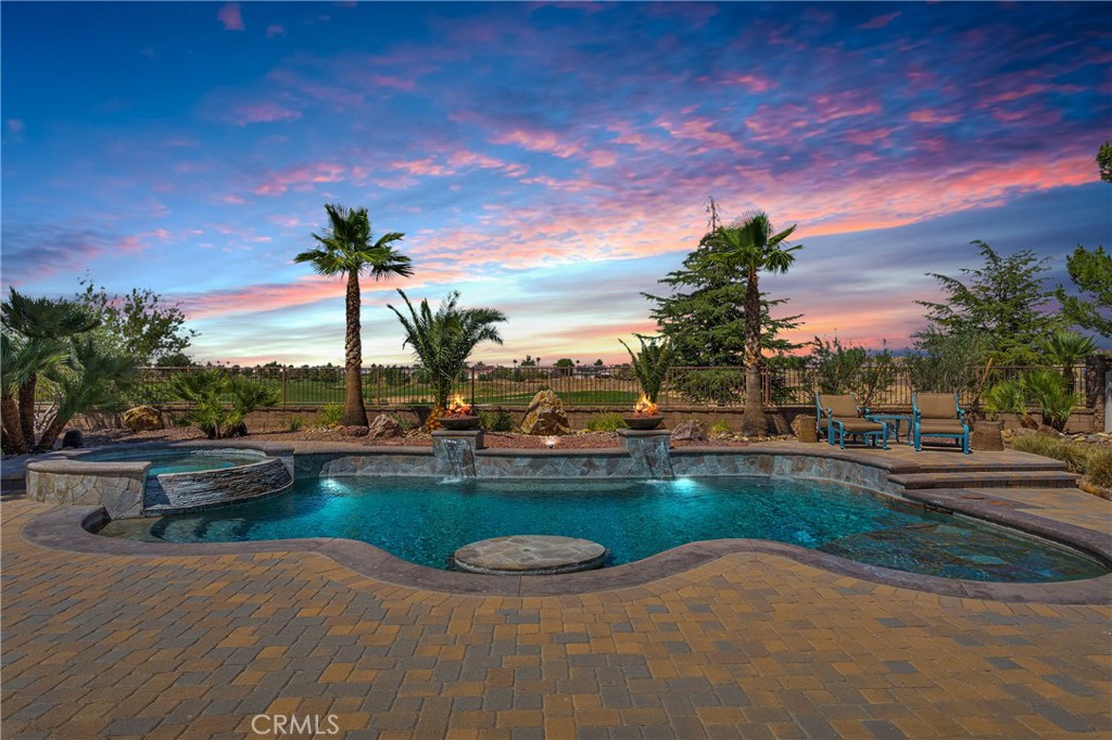***TURN-KEY Pool Home in Gated Community – The Estates, Apple Valley***
Experience luxury living in this immaculate single-story 4 bed, 2 bath home located in the highly sought-after gated community of The Estates***Boasting over $200,000 in upgrades—plus PAID SOLAR and 3 Tesla Powerwall batteries—this home WILL NOT DISAPPOINT and is designed for both comfort and efficiency***
Step into your private backyard oasis featuring a RESORT-STYLE POOL & SPA, complete with a swim-up table and lounge swim step, decorative pavers, outdoor kitchen with built-in BBQ, and covered patio with heaters***The lush setting is framed by mature landscaped trees/shrubs and custom outdoor lighting, with breathtaking GOLF COURSE VIEWS and a full Sonic surround system with 5 audio zones for indoor/outdoor enjoyment***
Inside, the home showcases natural stone flooring, a spacious OPEN-CONCEPT layout, stacked stone fireplace, plantation shutters, stain-grade cabinetry, stainless steel appliances, and a walk-in pantry***The luxurious primary suite offers direct backyard access, a spa-inspired bath with dual sinks, separate tub & shower, and a massive WALK-IN closet with built-ins***Epoxy-finished floors in the 4-CAR Garage with additional storage***