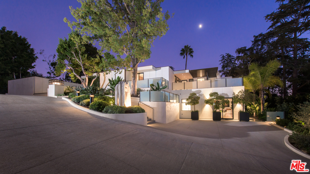 This gorgeous contemporary compound by master architect, A. Quincy Jones, has been flawlessly updated with todays best technology. Behind gates sits a serene estate complete with two spacious guest suites, both with their own private parking. The main bedroom features dual baths and closets, a second level for a gym/theater, and a terrific private balcony with fire pit. Beautiful walls of glass give way to water features seamlessly blending the outside in. Outdoor spaces offer a pool, bbq, pizza oven, fireplace, and fabulous oversized motorcourt, all surrounded by large, private flat grounds and city vistas beyond. A stunning architectural gem like no other!