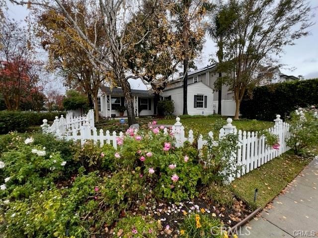 A True Colfax Meadows charmer with white picket fence, lush landscaping and lovely curb appeal. The inside will delight with character-rich touches throughout, living room with deep wood barrel accent ceiling, brick fireplace, wood floors, bay window and French doors that lead to the al-fresco dining area surrounded by a haven of lush plants and flowers. Beautiful and cozy kitchen with center island, stainless steel appliances and breakfast bar that opens to the family room (previously a 3rd bedroom). The dining area comes complete with beautiful built-in table and bench. The main bedroom features a pitched ceiling with hardwood planks and ceiling fan, the second bedroom is light and bright with decorative lighting fixture and beautiful built-ins, and 1 hallway bathroom with separate tub and shower. The charm continues into the tranquil backyard with abundant landscaping, a romantic gazebo. Corner property, ideal location, close enough to walk to the Tujunga Village with its many shops, eateries and entertainment and in a city known for their sought-after highly-rated schools!