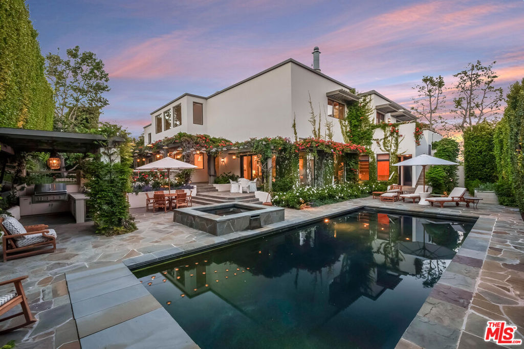 Nestled in the prestigious Riviera neighborhood on the highly coveted lower Amalfi Drive, this residence was meticulously reimagined and renovated in 2021. Just moments from Santa Monica and Brentwood and bathed in natural light, this gem seamlessly blends sophistication with functionality, making it perfect for both grand entertaining and effortless everyday living.The heart of this home is a stunning kitchen that defines family friendly culinary excellence. With soaring 26-foot ceilings creating an airy ambiance, it features a Lacanche range, Miele and Sub-Zero appliances, dual sinks, a spacious center island with barstool seating, a cozy breakfast nook, and a walk-in pantry with a secondary refrigerator, making this kitchen a joyful and inviting space.The main level also includes a formal dining room, a dramatic family room perfect as a cozy TV lounge, and a step-down living room with custom cabinetry, featuring a hand-carved marble fireplace mantle with walls of glass that overlook the garden and backyard sanctuary. The backyard boasts a sparkling pool, spa, outdoor bar, built-in grill, spacious turf field, herb garden, a dedicated dog run, lush greenery, and mature hedges for total privacy.The main level continues with multiple powder rooms, a laundry room, a gym (easily converted to a 6th bedroom) with cold-plunge and sauna, a spacious office with multiple workstations and a garden view, and finally, a large en-suite bedroom that feels like an additional primary suite with a large walk-in closet.Upstairs, four en-suite bedrooms offer comfort and style, accompanied by a dedicated homework station. The primary suite is serene, showcasing beautiful sycamore trees, ocean views, a private sitting area, a spa-inspired marble bathroom with a soaking tub, lavish shower, two huge custom walk-in closets, and a wrap around balcony perfect for watching the sunset. The lower level features a theater, a kitchenette, a powder room, expansive storage, and a three car garage equipped with electric car chargers. Every detail in this home reflects meticulous craftsmanship and great care. Features include Moroccan Limestone, European Oak floors finished in Northern France, Waterworks fixtures, Pierre Frey and Soane wallpaper, a HousePure commercial-grade whole home water filtration system, integrated indoor/outdoor speakers, and a comprehensive security camera network.Close to the coveted Riviera Country Club and surrounded by top-tier schools, including the highly rated Canyon Charter Elementary (10/10), this extraordinary residence in the Riviera is a rare opportunity to buy a wonderful home at an incredible value.