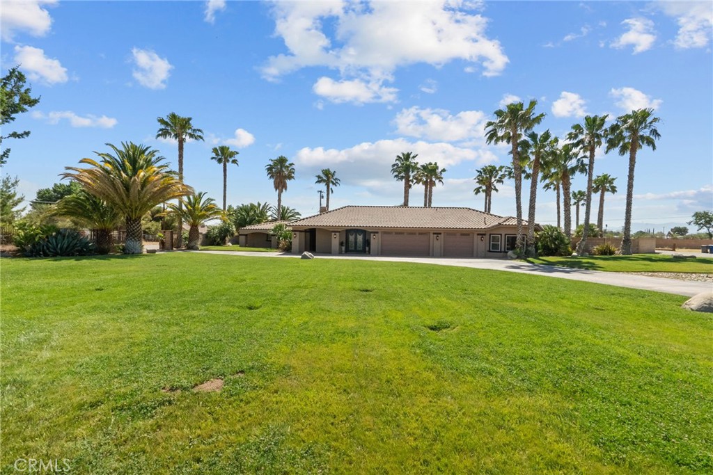 Welcome to your private oasis in the heart of Palmdale! This stunning 4-bedroom, 4-bathroom estate offers the perfect blend of comfort, luxury, and space on over 2 acres of land. From the moment you step inside, you’ll fall in love with the privacy and thoughtful design made for entertaining and everyday living.
The open-concept layout showcases elegant travertine flooring, granite countertops throughout, and a grand fireplace as the centerpiece for gatherings. The chef’s kitchen includes a spacious walk-in pantry and flows seamlessly into the formal dining room—perfect for hosting holidays and special occasions.
The primary suite features a cozy fireplace with custom stonework, a spa-like bathroom with dual shower heads, new granite counters, and updated glass enclosures. Two additional bedrooms toward the back of the home share a fully upgraded bath. A bonus room with a full bath on the opposite side of the house offers flexibility as a guest room, office, or fifth bedroom.
Step outside to a resort-style backyard complete with a built-in BBQ, mini fridge, sink, three ceiling fans, and retractable sunshades—ideal for summer relaxation. Enjoy your own tropical paradise with a sparkling pool and spa featuring a grotto, waterfall, lighting, and heating. An outdoor shower and a nearby full bathroom add ultimate convenience.
Car enthusiasts and hobbyists will love the 3-car garage with two car lifts and an attached ADU—perfect for guests or rental income. The ADU offers a full upstairs bedroom and bathroom, plus a downstairs living area. There’s even an additional structure currently used as a paint booth or bonus storage.
This rare property has it all: space, privacy, luxury, and income potential—your dream lifestyle starts here!