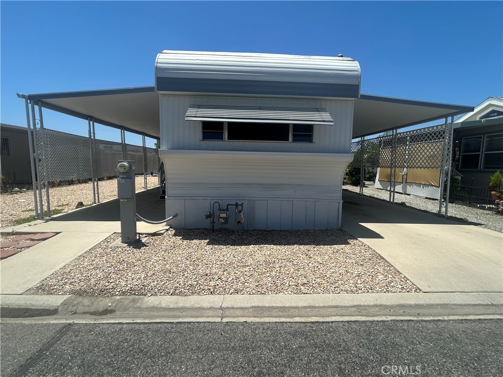 Oldie but goodie single-wide in centrally located Sunburst gate senior mobile home park. Living area has wood laminate flooring, mini and vertical blinds. Kitchen has gas stove, refrigerator, microwave, and loads of counter space. Primary bedroom has mirrored wardrobe door and built-in drawers. Bathroom with large shower, linen closet, and built-in laundry hamper. BOTH forced heat and air conditioning AND newer, economical evaporative cooler. 2 sheds (one with washer hook-up). Park amenities include swimming pool, spa and Clubhouse with recreation room, pool tables, card/game room, banquet facilities, indoor shuffleboard, and more. Affordable senior living!