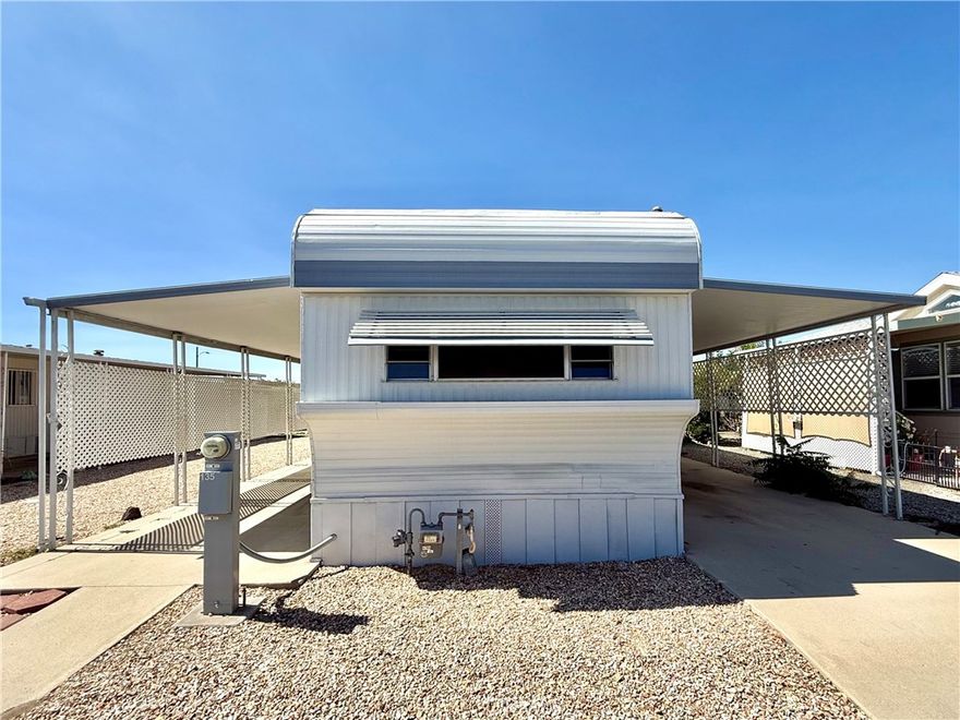 Oldie but goodie single-wide in centrally located Sunburst gate senior mobile home park. Living area has wood laminate flooring, mini and vertical blinds. Kitchen has gas stove, refrigerator, microwave, and loads of counter space. Primary bedroom has mirrored wardrobe door and built-in drawers. Bathroom with large shower, linen closet, and built-in laundry hamper. BOTH forced heat and air conditioning AND newer, economical evaporative cooler. 2 sheds (one with washer hook-up). Park amenities include swimming pool, spa and Clubhouse with recreation room, pool tables, card/game room, banquet facilities, indoor shuffleboard, and more. Affordable senior living!