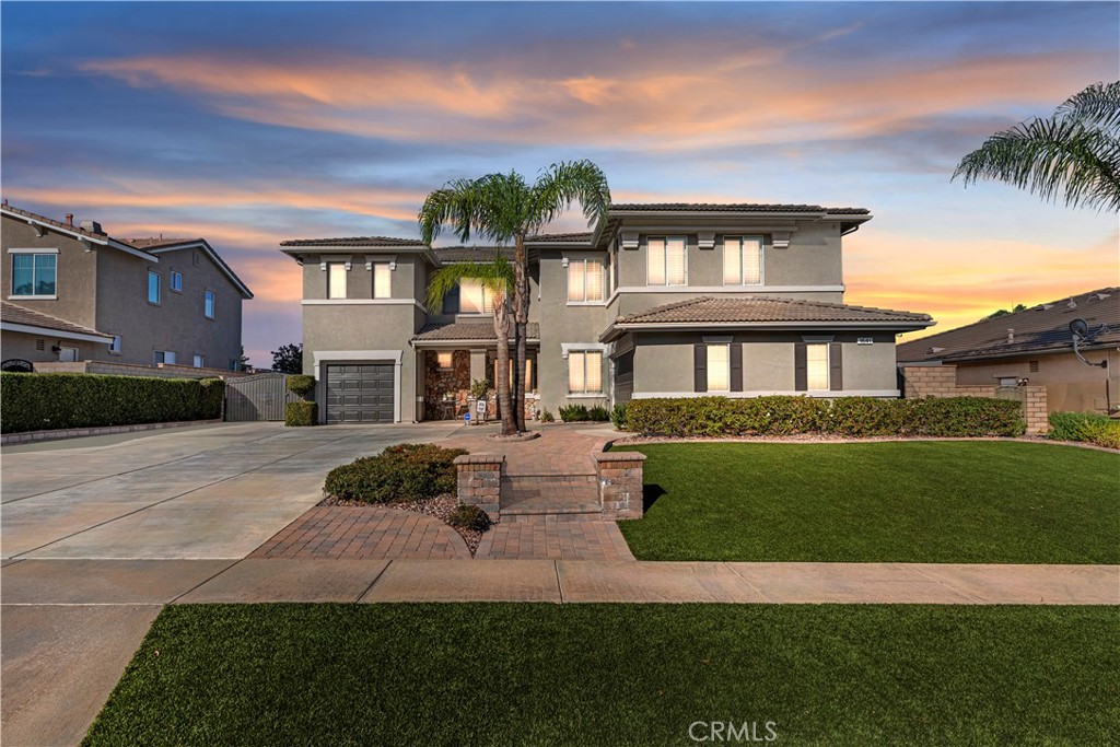 Welcome to 1641 Via Sevilla in Corona, CA — an exquisite executive residence nestled in the green hills of South Corona. Located just minutes from top-rated schools, shopping, dining, and convenient freeway access. Offering 5 bedrooms, 3 bathrooms, and approximately 3,486 sq. ft. of living space on a generous 10,454 sq. ft. lot, this home blends timeless elegance with thoughtful upgrades. From the curb, the home impresses with its easy-to-maintain landscaping featuring low-water plants and turf, an extra-large driveway, and a 3-car garage with RV parking potential. Beautiful double front doors with custom glass inlays provide a warm welcome into a bright and open floor plan. Inside, you’ll find refined details including wainscoting, wood shutters throughout, and an abundance of natural light. The spacious living and dining rooms flow seamlessly into the family room, enhanced with a custom surround-sound system for an immersive experience. The kitchen is truly the heart of the home, showcasing a large center island, granite countertops, a walk-in pantry, and newer appliances (dishwasher just one year old, microwave two years old). A central vacuum system adds modern convenience, while the upstairs offers generously sized bedrooms along with a large bonus room—perfect as a game room, home office, or media space. The backyard retreat is designed for both relaxation and entertaining. Enjoy the shade of the Alumawood patio cover, gather around the firepit, or host barbecues at the built-in outdoor kitchen. The sparkling rock pool and spa have been refreshed with cleaned tile and repainted rock features, while the pool heater and pump were recently replaced for worry-free enjoyment. Additional highlights include paver hardscaping, a dog run on the side yard, and easy-access outlets for Christmas lights conveniently controlled from inside the home. Practical upgrades such as two HVAC systems, a Brinks alarm system with cameras, and recently replaced garage doors and exterior paint (completed one year ago) add both comfort and peace of mind. With its combination of resort-style amenities, energy-conscious landscaping, and premium location nestled in the hills, 1641 Via Sevilla offers the ultimate Southern California lifestyle.