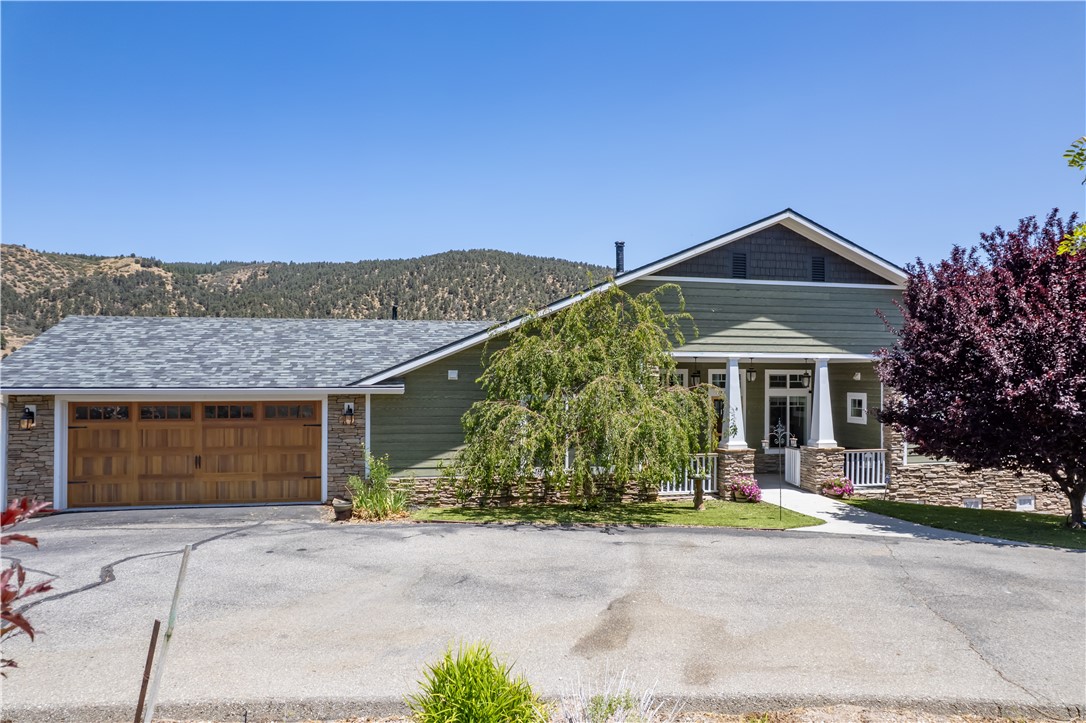 GORGEOUS CUSTOM CRAFTSMAN STYLE HOME ON ONE EQUESTRIAN ZONED ACRE, LOCATED IN THE DESIRABLE PINON PINES ESTATES!! This 4 bedroom 3 full bath home was built with special attention to detail, beauty, convenience and safety. As you enter you're welcomed into the charming covered front porch. Walk through the front door into the great room and be instantly captivated by the unobstructed panoramic view, grand vaulted wood beamed ceiling and massive stone fireplace. The 3 bedroom, 2 bath main floor has a light and bright open floor plan with lovely teak wood flooring, new carpet, large windows and glass doors to let the light and views in. Located just off the great room is the spacious chef's kitchen. Granite counters, subway tile backsplash, high-end appliances and large island with beverage fridge. Beautiful wood cabinets and drawers are soft closing with pull-outs and 2 Lazy Susans for easy storage. The kitchen opens to the dining area with plenty of room for seating and a glass door opens to an amazing low maintenance deck that's a great place to BBQ, relax, entertain and enjoy the mountain views and starry nights! Down the hall is a bedroom with built-in desk, and a full bath with subway tile shower, soaking tub, Carrara marble vanity and white octagon floor tile. Just up the hall is a bedroom that could be a his and hers office, with an extra deep closet that could be office space or a reading nook. Further up the hall is an indoor laundry room with sink basin that opens to the 2-car garage and workshop. The primary bedroom with walk-in closet is located on the other side of the great room with a glass door that opens to the back deck. The primary bathroom has a granite dual sink vanity, travertine flooring, walk-in shower and soaking tub with a view. JUST DOWN THE STAIRS IS AN ENTIRE SEPARATE LIVING AREA! The living room has a sliding glass door that opens to a private covered patio. There's a bedroom with lots of closet space, full bath, kitchenette and ANOTHER 2-CAR GARGAGE and workshop with separate driveway and entry. The front landscaping has turf and a drip system for the plants, rosebushes and many mature trees. The backyard has a retaining wall and French drains. Tankless water heater, plumbing/electrical for a spa, deep reinforced concrete foundation, cement siding, ceiling sprinklers for fire safety. Just 40 minutes to Santa Clarita and Bakersfield where you'll enjoy 4 seasons of nature in a quaint mountain community. This is a MUST SEE!!