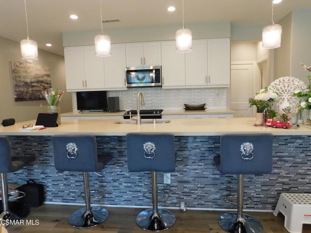 A+ PERFECT, tastefully decorated and upgraded Townhome located in prestigious Wood Ranch! This property is situated in a peaceful and quiet cul-de-sac street which makes it a private place to come home to! As you enter the foyer on the first level, you are greeted inside the inviting, light and bright, OPEN-CONCEPT floorplan. The remodeled gourmet kitchen offers high end stainless steel appliances, white shaker cabinets with quartz counters, custom overhead lighting and an oversized island with bar stool seating, perfect for entertaining! The open Dining and Living rooms have everything you need, including a gorgeous fireplace to warm up to! Mountain views from the picture windows are breathtaking! You may also admire the views from the outdoor patio! Enjoy the community pool and spa, just in time for summer! This 3 bed, 3 bath home also includes an additional large Loft upstairs which can be used for multiple purposes. Spacious Primary Bedroom/Bath Suite provides white shaker bath cabinets, quartz counters, dual vanity sinks, a separate tub & shower and an exceptionally large walk-in closet! Convenient indoor laundry room includes a washer, dryer, a soaking sink and built-in shelving. Many more upgrades found in this home are too much to mention so best come for a visit! Ask about furnishings.
