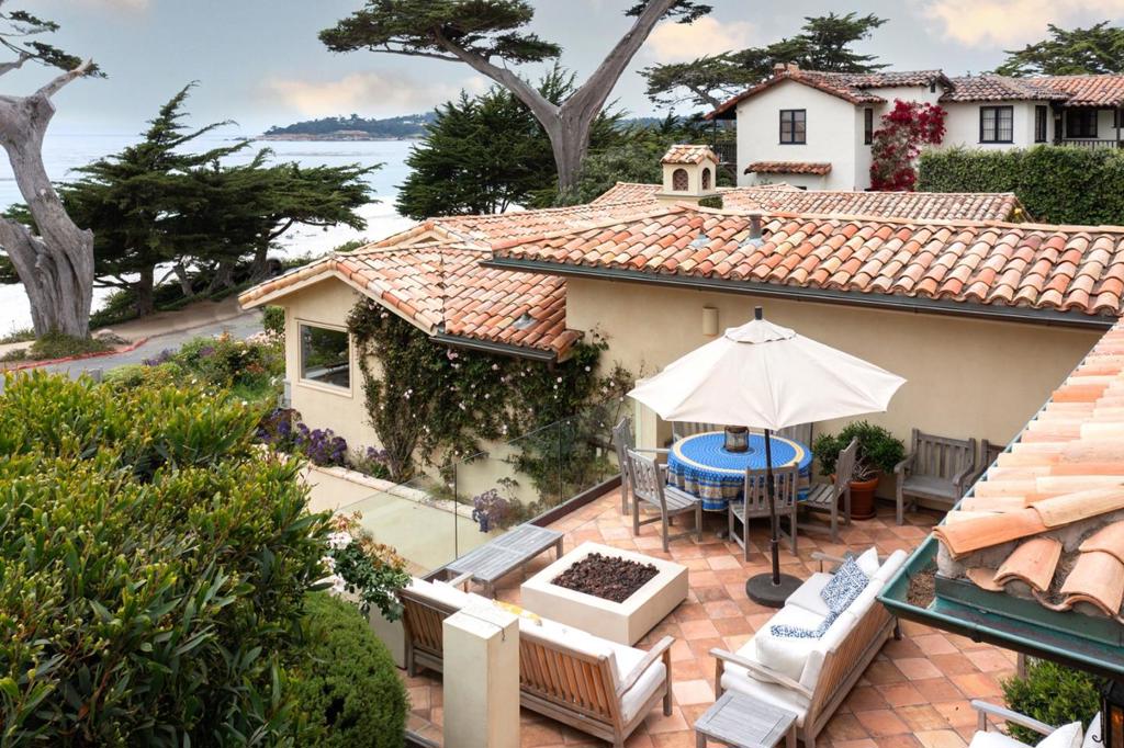 Not thirty yards from Carmel Beach and easy walking distance to Carmel's world-class restaurants and shops, this exquisite and spacious Cottage is set on one of the largest and best lots in Carmel-By-The-Sea. The stylish and remodeled home offers 4 bedroom suites and 4.5 baths, a spacious family room, and a comfortable living room with ocean views that opens up to the stunning center courtyard, gardens, and lovely patio with fire pit. Other features include a 2-car garage, chef's kitchen with cozy breakfast nook, secluded office with beautifully crafted custom-built desk and cabinetry. The capacious home offers unobstructed views from Pebble Beach to Point Lobos and Carmel Point and is reminiscent of seaside homes found gently nestled in the hills above romantic destinations such as St. Tropez, Monte Carlo or Cannes. This extraordinary residence is ready for its loving new owners to move in and enjoy the quintessence of Scenic Carmel lifestyle.