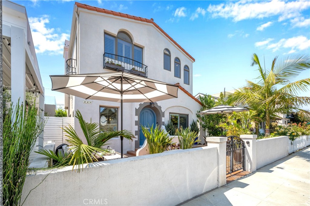 Welcome to this stunning two-story Spanish-style home, perfectly situated just steps from the vibrant shops and restaurants of 2nd Street—and only moments from the beach. This 3-bedroom, 2-bathroom residence seamlessly blends timeless architectural charm with modern upgrades throughout. A lush front patio sets the tone, offering the ideal setting for morning coffee or al fresco dining under the stars. Step inside to find a warm and inviting living room with an upgraded cozy fireplace, original arched doorways, and rich character details. The remodeled kitchen is a chef’s dream, featuring quartz countertops, stainless steel appliances, custom cabinetry, and an effortless flow to a private patio—perfect for entertaining. Both bathrooms have been tastefully updated with high-end finishes. Upstairs, the expansive primary suite is a true retreat, boasting an extra large walk-in closet, large bathroom that includes a gorgeous free standing bathtub and French doors that open to a private deck for your morning yoga or evening unwind. A rare two-car garage and additional parking pad offer the ultimate convenience for Belmont Shore living. This one-of-a-kind home captures the essence of a coastal lifestyle—stylish, comfortable, and just a short stroll to sand, surf, and city buzz.