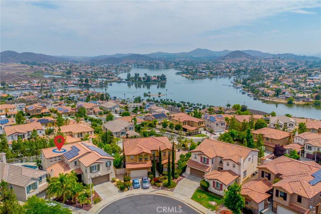 Stunning Lake View Pulte Home with Luxurious Features and Resort-Style Backyard. Welcome to 29 Plaza Lucerna, this beautifully appointed 4-bedroom, 3.5-bathroom home offering 3,404 square feet of elegant living space with breathtaking lake views and luxurious upgrades throughout. Step inside to discover tiled flooring, crown molding, and a striking two-tone stair banister that sets the tone walking through the open concept. The home features both a formal living room and formal dining room, perfect for entertaining, along with two cozy fireplaces that add warmth and charm. The gourmet kitchen is a chef’s dream, equipped with stainless steel appliances, a cooktop with hood, granite-tiled countertops, and a convenient butler’s pantry. The family room opens seamlessly to the kitchen, creating a welcoming space for gatherings. Retreat to the expansive master suite, complete with a private sitting area, deck with panoramic lake views, and a spa-like master bathroom featuring a sunken tub, tiled walk-in shower, and elegant vanity. The home also includes Jack and Jill bedrooms, ideal for all families. Additional highlights include AC units, Water Heater and exterior paint within the last two years, ceiling fans in every room, plantation shutters, and abundant natural light throughout. Step outside to your resort-style backyard oasis featuring a sparkling pool, relaxing spa, built-in fire pit, and outdoor BBQ—perfect for enjoying Southern California living year-round. This exquisite home offers the perfect blend of comfort, luxury, and scenic beauty. Low tax rate of only 1.3%. Don’t miss the opportunity to make it yours! Virtual Walk through Coming Soon!