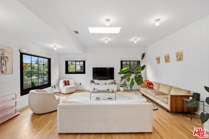 This beautifully reimagined Spanish effortlessly fuses timeless charm, classic architecture, and elevated modern living. With a 3 bed, 3 bath main house + a converted garage with a full bath, this character-rich home delivers everything from soaring skylights to abundant natural light, vintage stained-glass windows and an airy open layout. At the heart of the home sits a spacious cook's kitchen, thoughtfully designed for both form and function. It features a large center island, Carrara marble countertops, handcrafted tile, and sleek custom cabinetry ideal for casual dining or upscale dinner parties. The primary suite offers a peaceful haven and is fit with a walk-in closet, a spa-like en-suite bath, and bi-folding doors showcasing calming views and access to the manicured backyard and pool.  A private and lush backyard invites seamless indoor-outdoor living, equipped with a grassy sitting area, patio and pool.  The bonus converted detached garage provides its own functional living space, a bedroom and full bathroom, adding incredible flexibility perfect as a guest suite, creative studio, or the ultimate poolside lounge. Tucked away on a quiet street just moments from the best of Melrose and Beverly, this one hits every note: timeless, stylish, and completely dialed in.