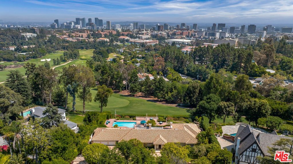 Commanding an unrivaled front-row position in Lower Bel Air, overlooking the 17th hole of the world-famous Bel Air Country Club, this timeless residence stands as a rare opportunity to craft your own masterpiece in one of Los Angeles' most iconic settings.Inside, a flowing single-level floor plan connects expansive living spaces with generous bedrooms that feel like private retreats. Traditional french doors invite natural light throughout, framing serene golf course and city views while enhancing the home's effortless sense of openness and scale. Outdoors, the property transforms into a private resort, designed for both grand entertaining and everyday relaxation. Gather beneath the tiki hut bar, take a dip in the swimmers pool, unwind in one of three hot tubs, or enjoy unforgettable evenings dining alfresco as the sun sets to the west, casting a golden glow across the fairways and skyline beyond. A residence of this caliber is more than a home, it is a once-in-a-generation opportunity to claim a front-row seat in one of Los Angeles' most storied and prestigious settings. A true "hole in one." First time on the market in over 50 years!