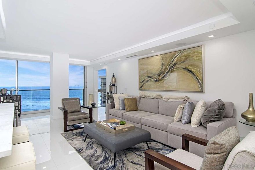 It's easy to perfect the art of living when you live within a work of art. Panoramic views of the Pacific Ocean and southern vistas of the San Diego Harbor & Silver Strand await you when you open your private door to paradise. This sparkling beautifully appointed spit floor plan has 2 Master bedrooms with en-suite bathrooms, and is an immaculate property for those with refined taste. The enlarged master-suites each share ocean views and are remodeled with separate walk-in closet spaces. The bright airy kitchen has an open space floor-plan integrating state of the art stainless-steel appliances, exquisite marble countertops and a cozy wine refrigerator. The third guest bathroom is just off the entrance just past the pantry closet. Floor to ceiling windows slide completely open to allow for true indoor/outdoor living and the bar is situated adjacent to the glass balcony railing, the perfect location for an afternoon delight. The balcony has been built out to increase interior square footage. This unique property has smart home features including surround sound Bose audio speakers in each room, 2 Smart QLED TV's, high-speed internet and dimmable led lighting throughout. The bedrooms have blackout shades or screen shading options on remote as well as sound machines for those discerning guests who prefer to sleep late or enjoy a relaxing seaside waves soundscape. Located in the famous upscale gated-community, The Shores at Coronado, seclusion is preserved while maintaining ultimate beachside privacy.