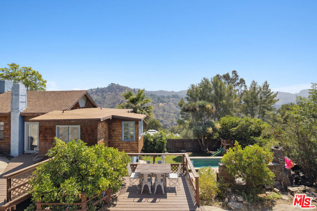 This newly remodeled canyon home features 3 + 2 main house plus a detached studio. Situated in the heart of Fernwood with cool ocean breezes and commanding views in all directions. Enter into the living room with open beamed vaulted ceilings, fireplace, and cozy wood floors. The country kitchen has been remodeled to perfection. The primary suite features a new bathroom as do the 2nd and 3rd bedrooms. There is also a detached studio space perfect for yoga, art, office, etc. The property offers great privacy, stunning rock outcroppings, and a sparkling pool & fenced grassy lawns for the littles and the pups. Located at the end of a small cul-de-sac with plenty of parking plus the coolest 2 car garage that was literally carved into a cave in the rock. This property is what the Topanga Life is all about. Furnished and ready to rent.