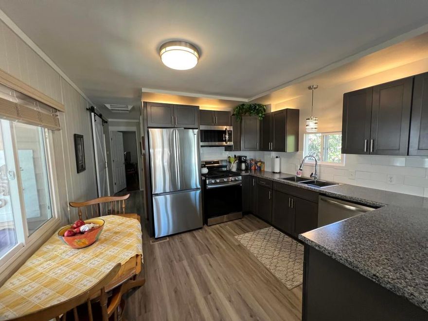 Completely Remodeled & Well-Maintained Home!This beautifully upgraded 2-bedroom, One and 1/2-bath home offers comfort, style, and move-in-ready living. The fully remodeled kitchen and bathrooms feature modern stainless steel appliances, all included in the sale along with all the furniture. Enjoy double-pane windows and sliding doors with internal blinds, plus laminate flooring throughout.Relax in the spacious and inviting patio areas -- perfect for unwinding after a long day -- with two patio decks to enjoy the views. The property also includes a convenient one-car garage with washer and dryer, a storage shed for tools and personal items, and is one of the few homes in the community featuring a cellar for extra storage.Located in the beautiful Desert Crest Country Club, a 55+ senior own-your-own-land community (no space rent!) with low $148 monthly dues. Amenities include unlimited golf on a 9-hole par-3 course, a genuine hot mineral water pool and spa, clubhouse with game room, library, gym, entertainment facilities, and 8 enclosed shuffleboard courts.All streets are county owned and maintained, with city water, sewer, natural gas, and cable/satellite services. Desert Crest offers an active lifestyle with aqua-aerobics, longevity (stick) exercises, line dancing, weekly gatherings, dinner dances, bingo, golf, and shuffleboard -- making it the perfect place to live and play!