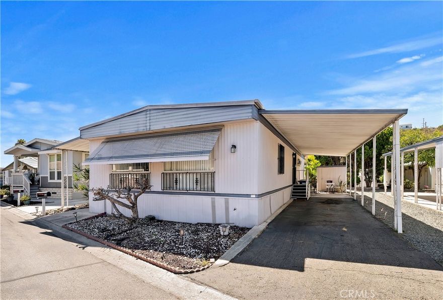 55+ COMMUNITY - Welcome to Leisureland #69! This well kept and beautiful manufactured home has 2 bedrooms and 2 full bathrooms. It is situated in Leisureland Mobile Villa, a 55+ Senior Community where the homeowner must be at least 55 years old. The home includes a kitchen with appliances and a breakfast nook, a spacious living room, a laundry room with washer and dryer, a primary bedroom with an ensuite bathroom featuring a spacious shower and walk-in closet. The property has a good size lot with storage unit, porch, and 2 car carport. Leisureland Mobile Villa is well maintained and is located near grocery stores, malls, restaurants, banks, post office, transportation, and freeways (805, 15, and 94). Furthermore, the community is at a private location next to the secluded 23 acres Chollas Open Space Trails. The home is adjacent to the upcoming Leisureland building project that will feature a new clubhouse with a kitchen, card room, billiard room, shuffleboard, and pool. The community Leisureland offers resident-planned activities and maintains common areas, including a spacious laundry room with large washers and dryers, a library/game room, clothes-line drying area and resident-maintained garden area. Schedule your appointment today to explore this opportunity to live at a great location.
